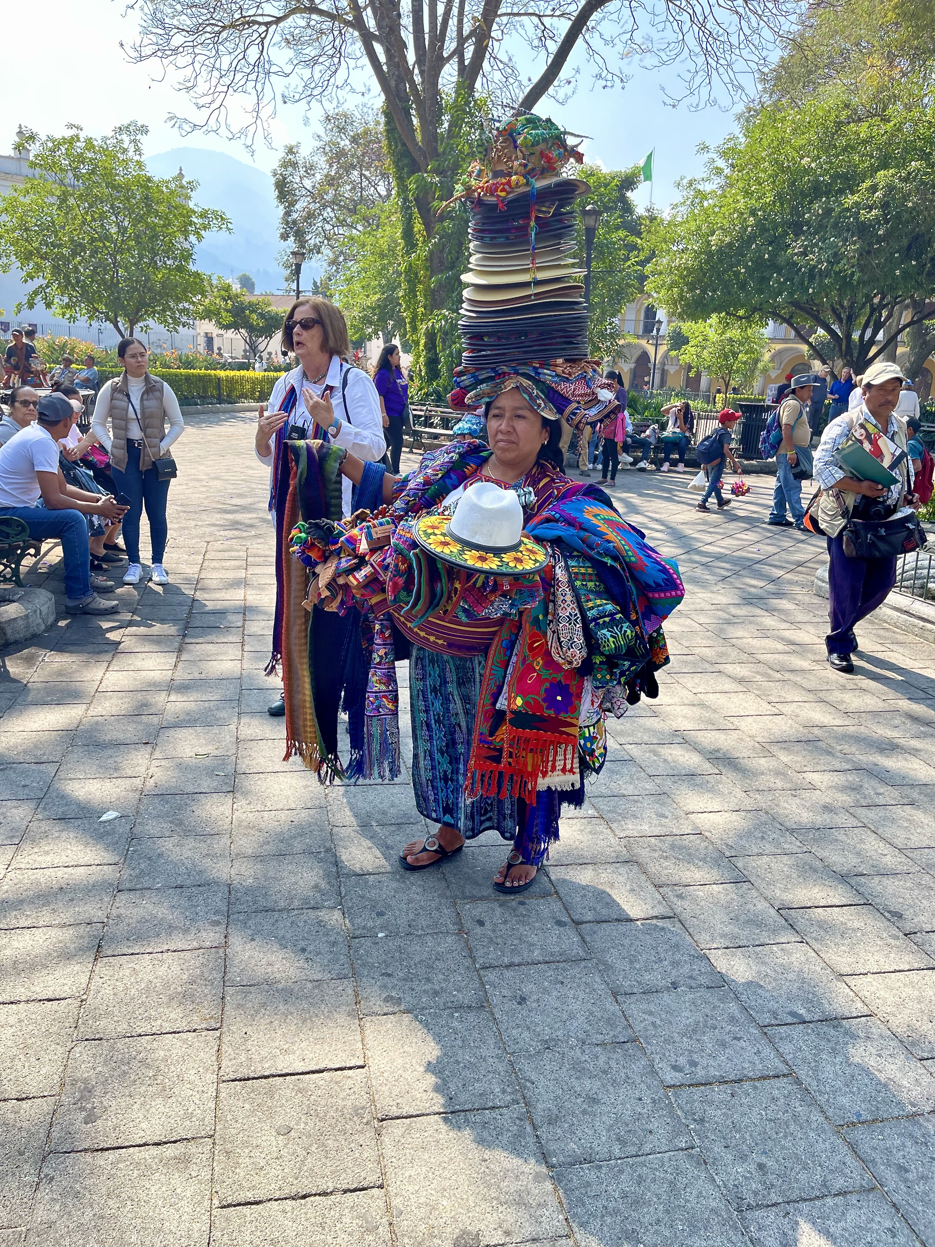 Maya woman in Parque Central selling hats and clothes. The hat stack can weigh up to 50 pounds.
ANNE SURCHIN