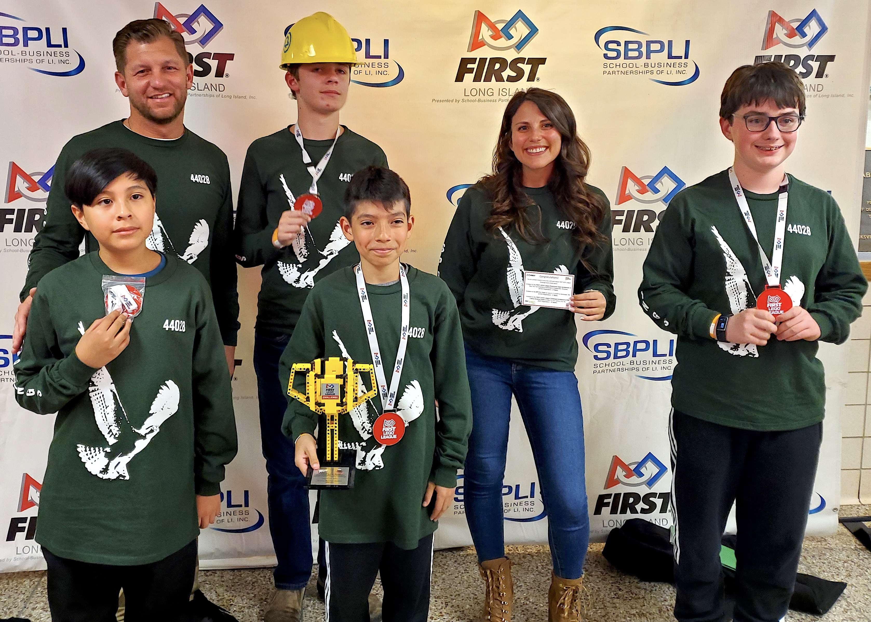 Springs School's Lightning Bots members Adrie Quinn, Austin Allen, Max Oransky and Adrie Quinn with club co-advisors Erik Schwab and Laura Foti and their Rising All-Star Award received after competing in the FIRST LEGO League Long Island Championship at Hicksville High School. SPRINGS SCHOOL DISTRICT