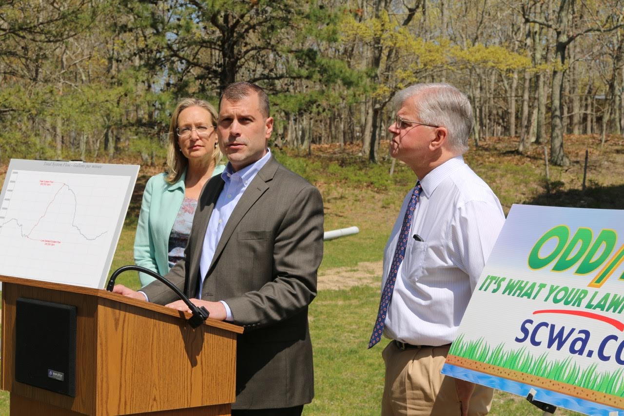 Jeffrey W. Szabo (center), CEO of the Suffolk County Water Authority, announced a program to spread out peak water demand imposed by automatic lawn irrigation systems at a press conference on Thursday, May 12 with County Legislator Bridget Fleming and State Assemblyman Fred W. Thiele Jr. at the water authority tower and pumping station off Middle Line Highway and Division Street in Sag Harbor. Peter Boody photo. 