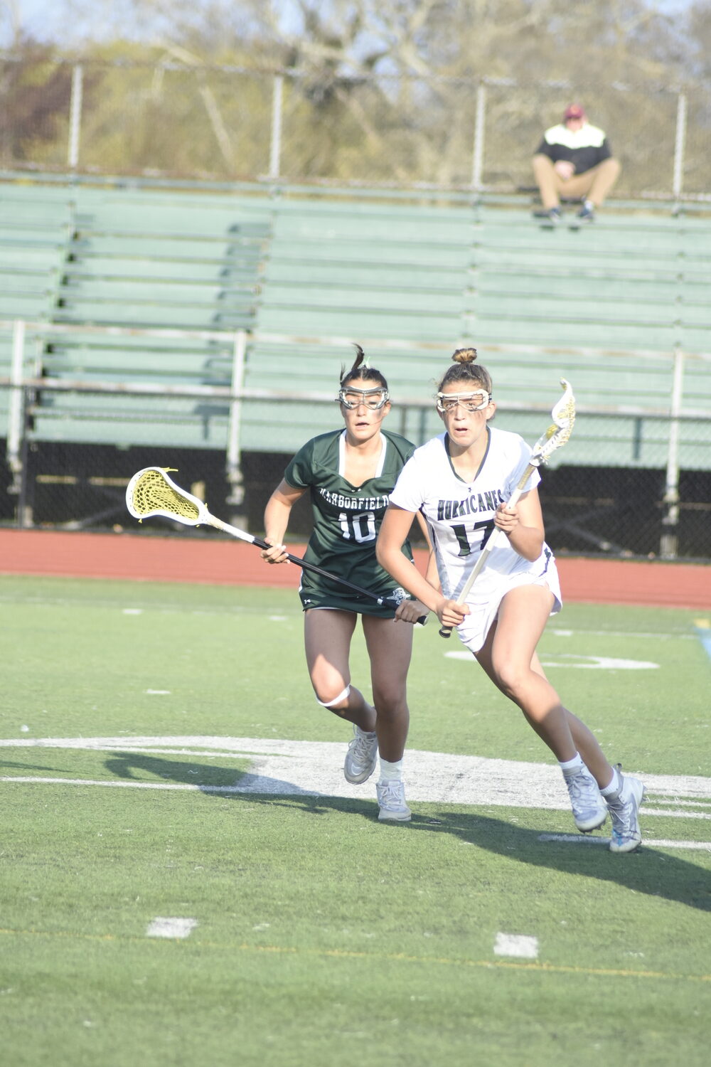 Sophomore midfielder Reese King grabs the ball on the opening draw of last week's victory over Harborfields. DREW BUDD