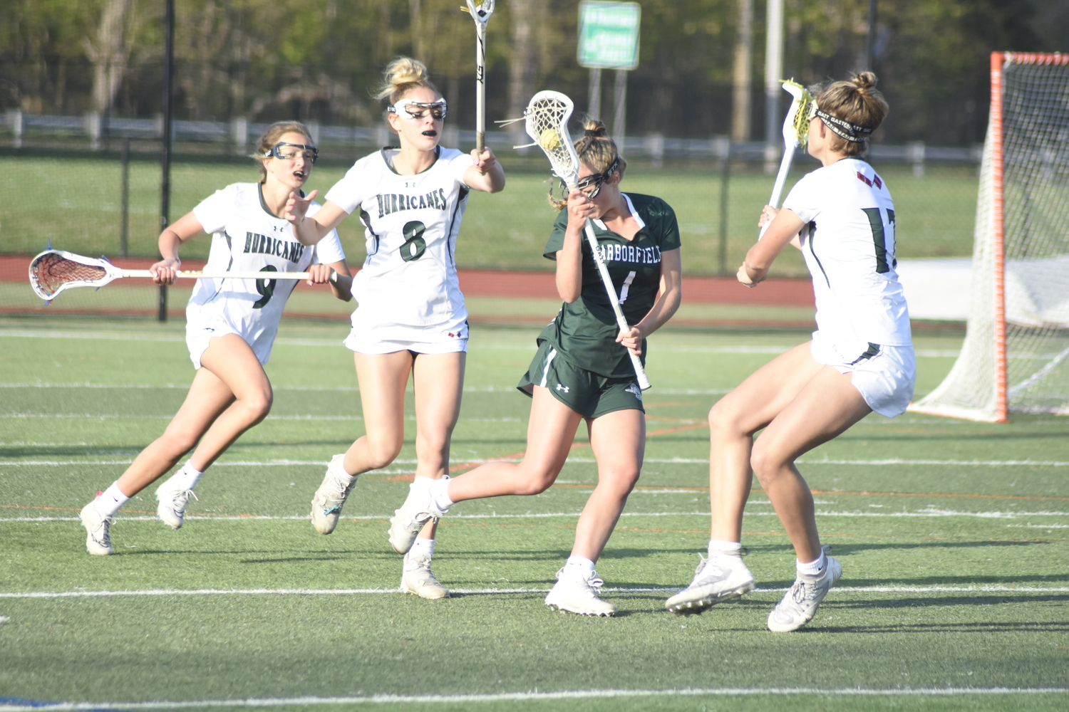 Peyton Worby, Ava Derby and Reese King swarm a Harborfields player trying to exit her own defensive end. DREW BUDD