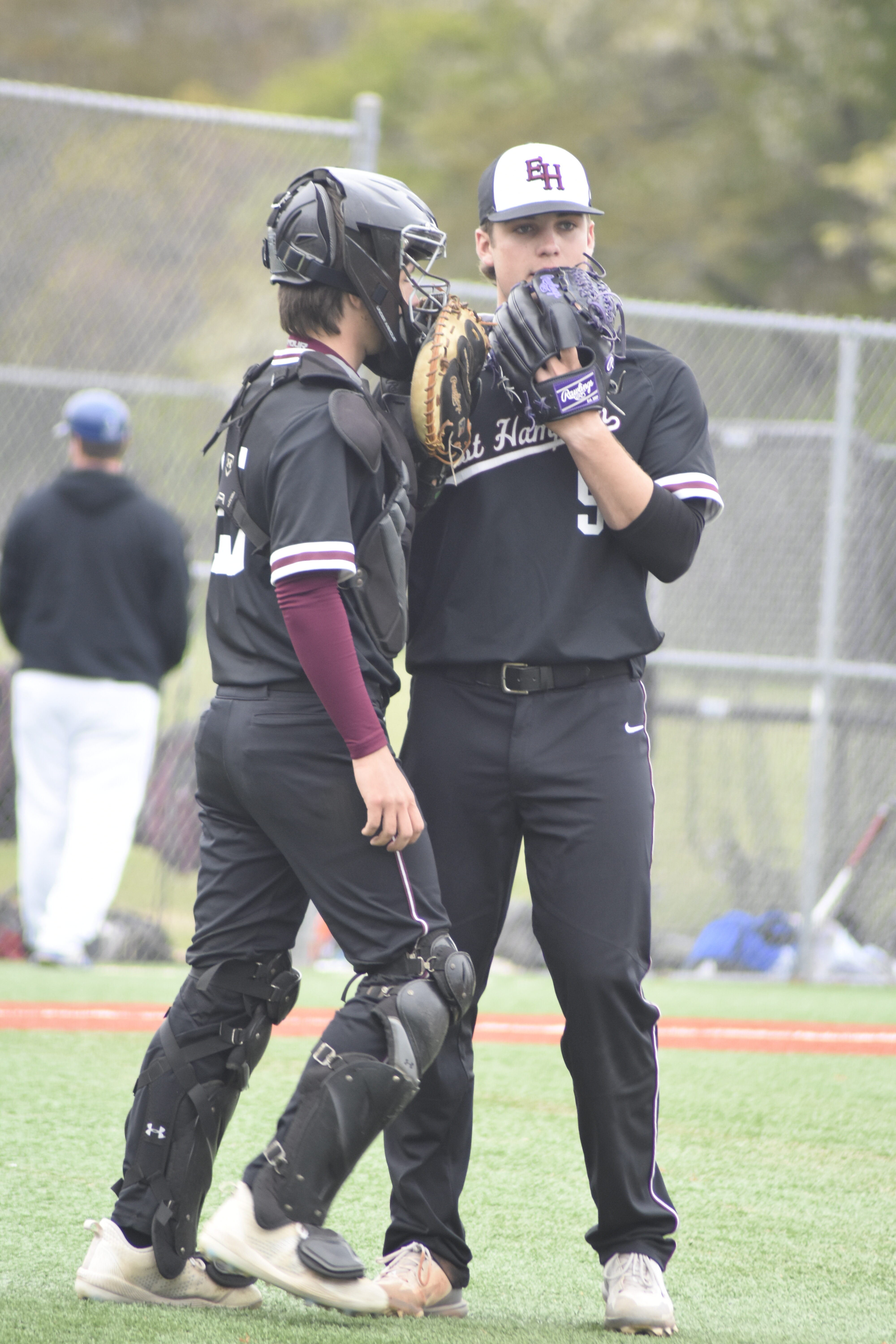 East Hampton starting pitcher Jack Dickinson goes over a few things with his catcher Nico Horan-Puglia.   DREW BUDD
