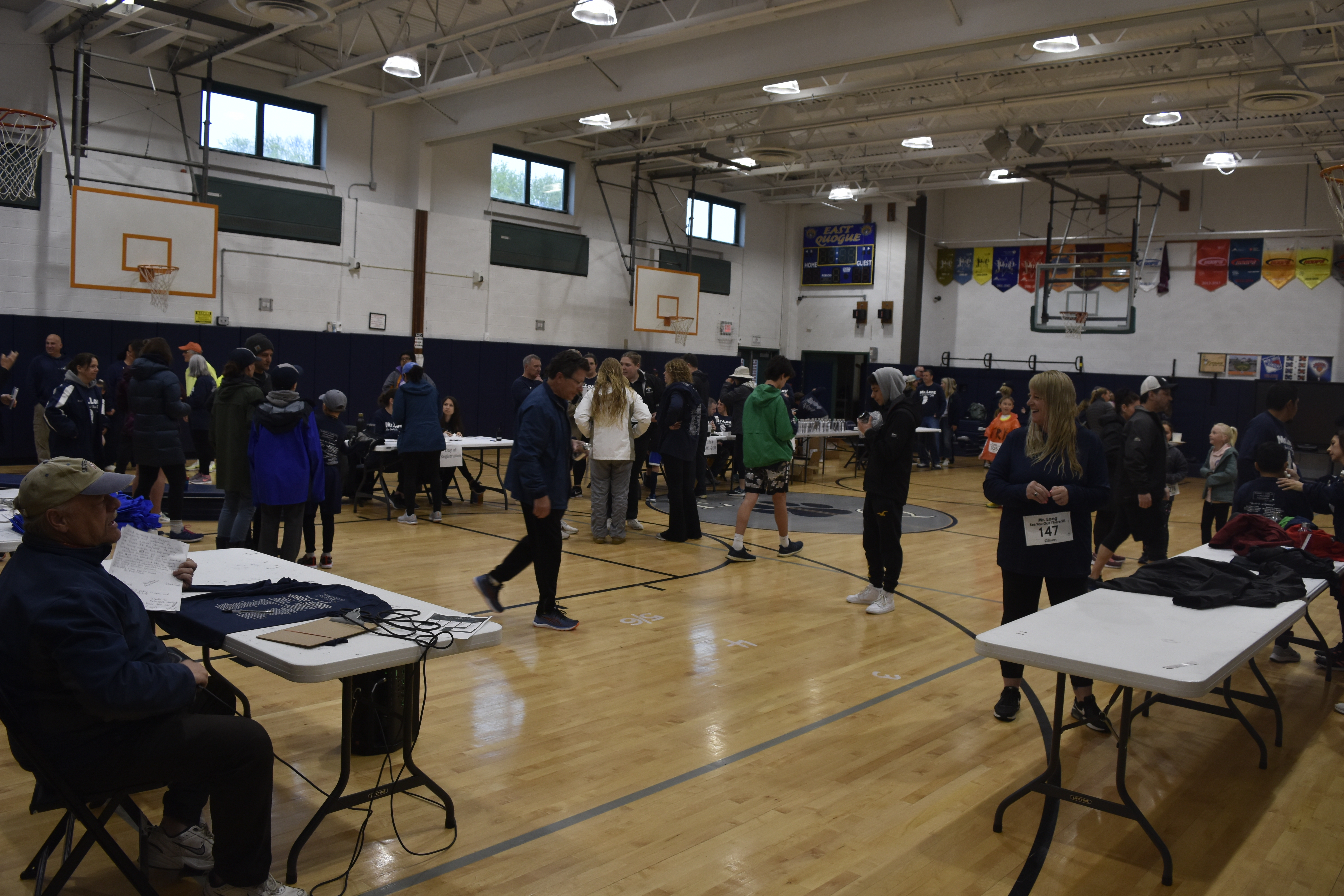 People pour in to the gym at East Quogue Elementary School on Saturday morning just prior to the Rob Long 'See You Out There' 5K.   DREW BUDD