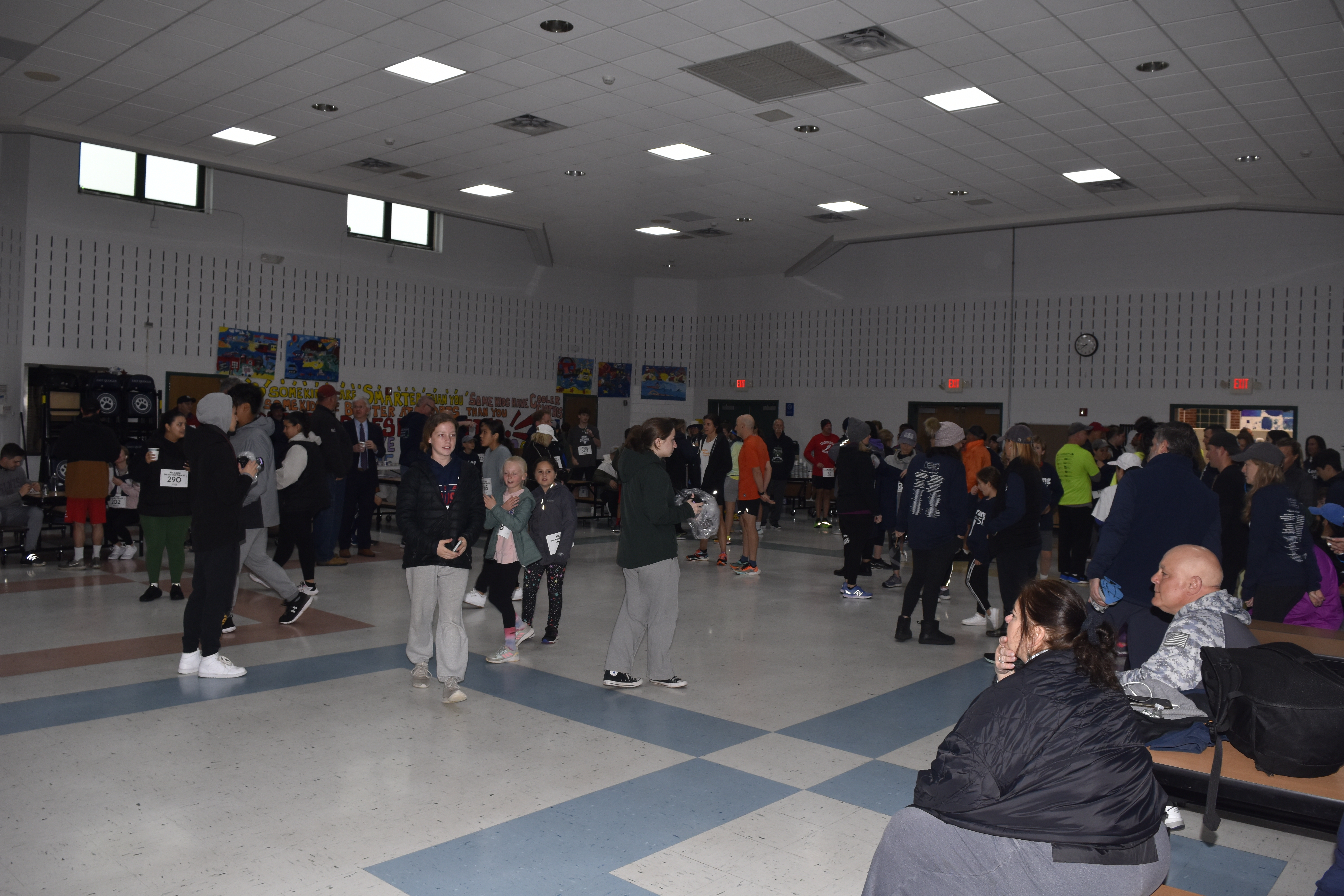 People start to pour in the cafeteria of East Quogue Elementary School for the opening ceremony of the inaugural Rob Long 'See You Out There' 5K.   DREW BUDD