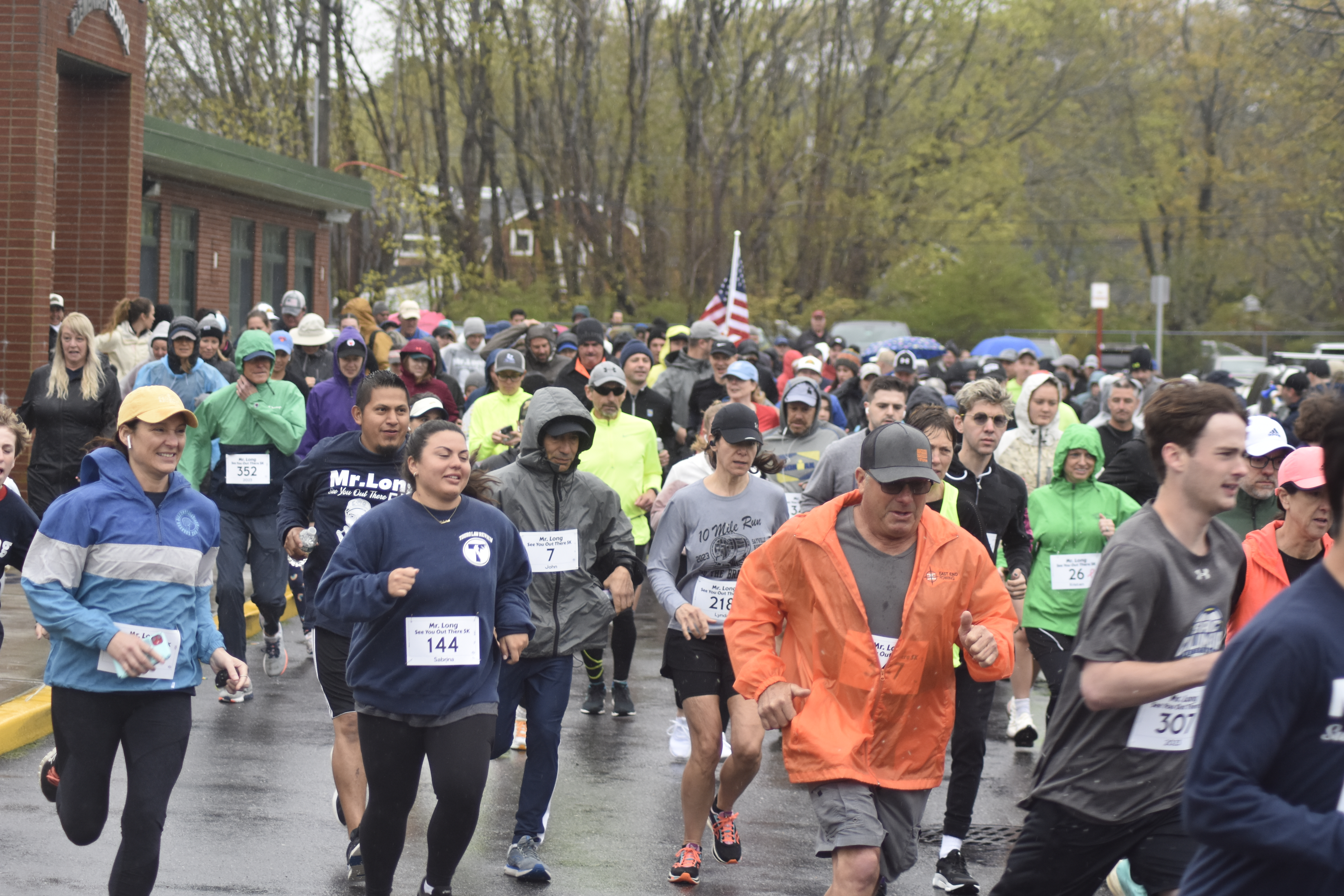 Runners and walkers start the inaugural Rob Long 'See You Out There' 5K at East Quogue Elementary School on a rainy Saturday morning.   DREW BUDD