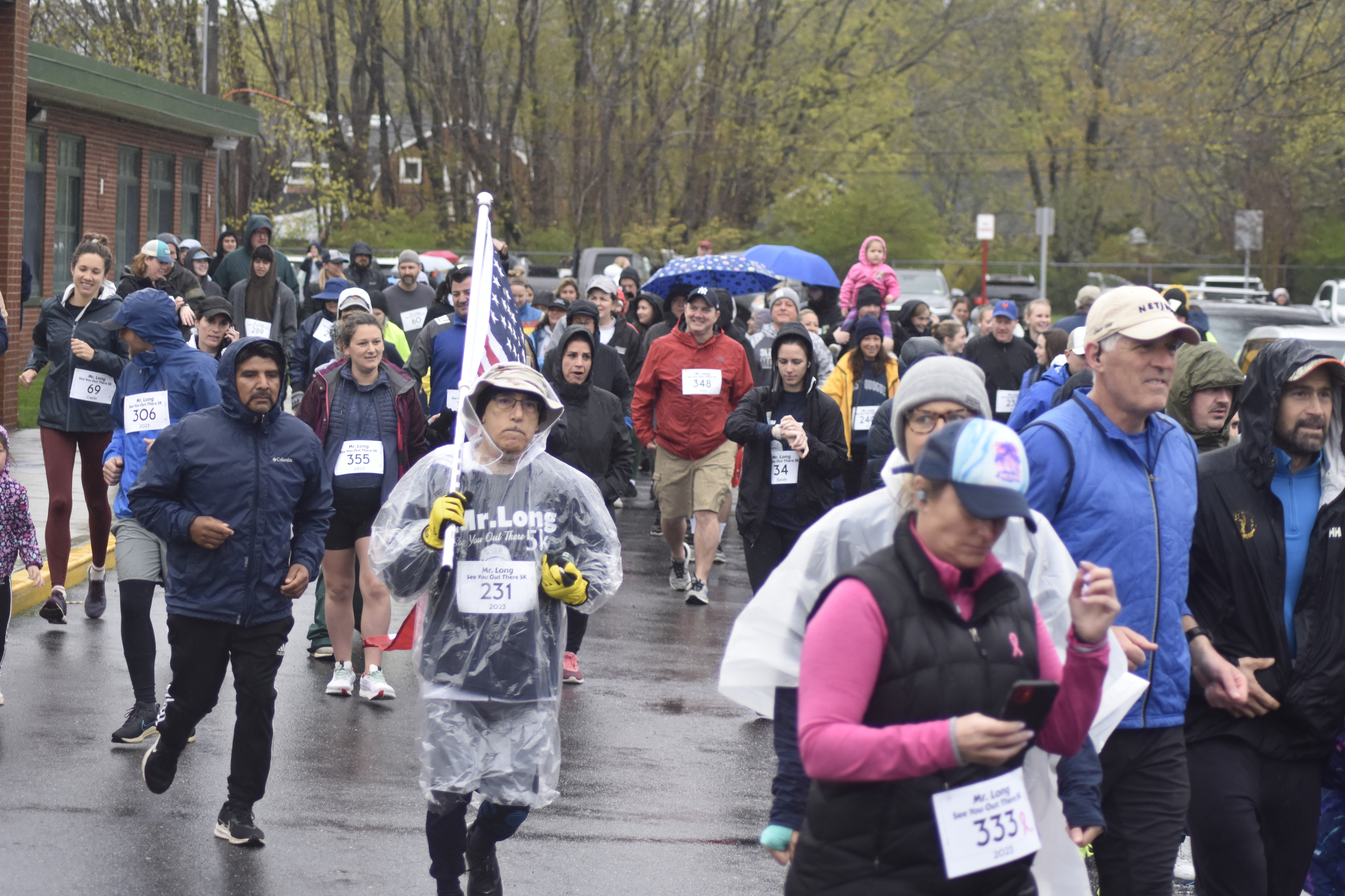 Runners and walkers start the inaugural Rob Long 'See You Out There' 5K at East Quogue Elementary School on a rainy Saturday morning.   DREW BUDD