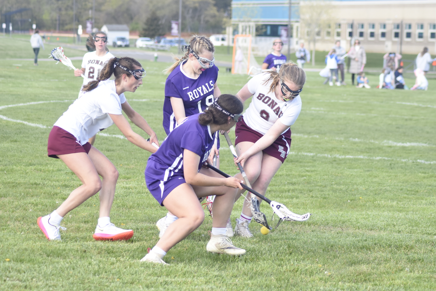 East Hampton senior Claire McGovern goes to scoop up a ground ball after sophomore teammate Ava Tintle caused the turnover.   DREW BUDD