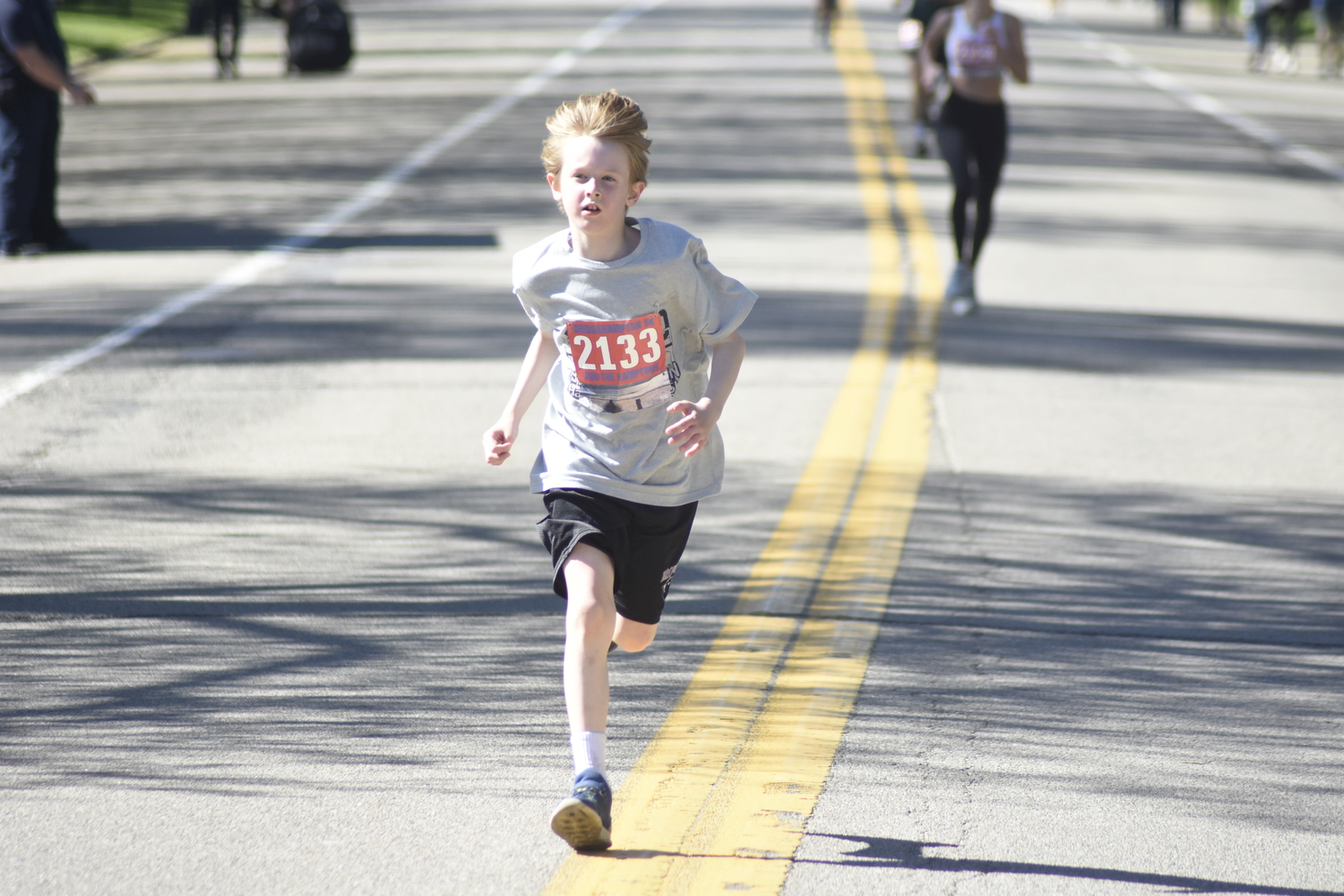 Henry Newton, 8, of New York City races toward the finish line.   DREW BUDD