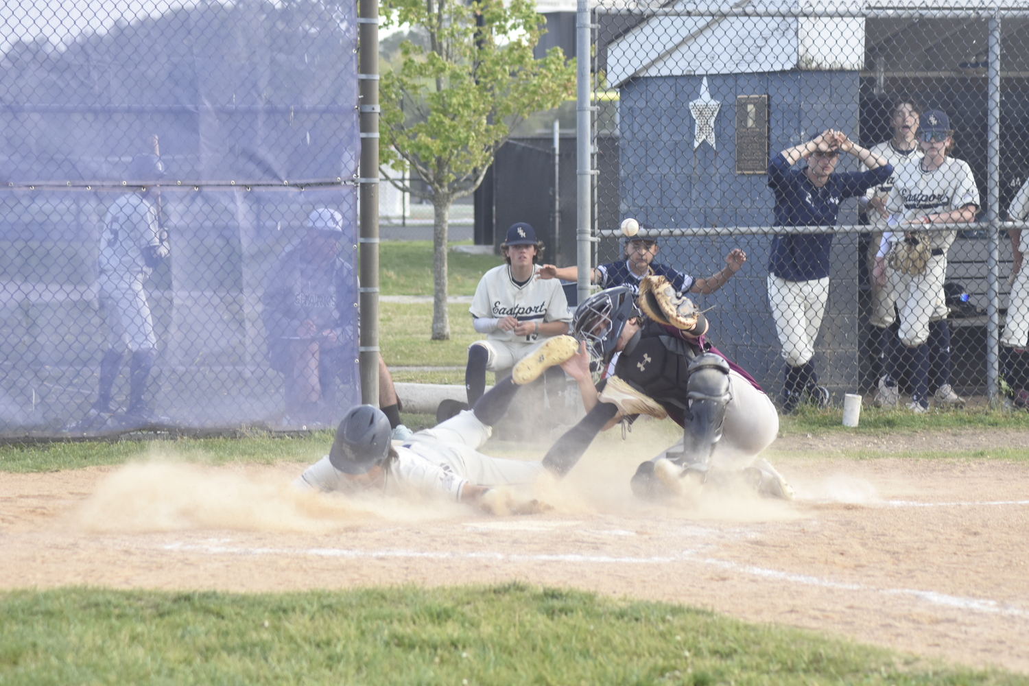 Bonac catcher Nico Horan-Puglia can't hold on to a throw to try and stop an ESM player from scoring.   DREW BUDD