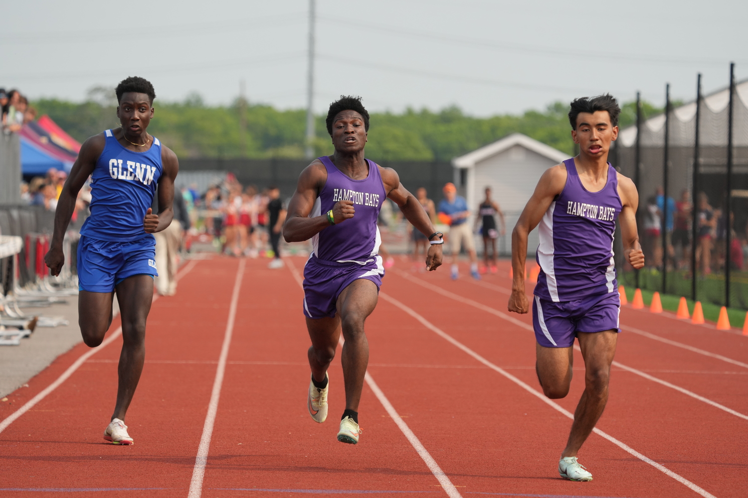 Baymen Charlie Garcia, far right, and Eli Amos placed second and third, respectively, in the 100-meter dash.   RON ESPOSITO