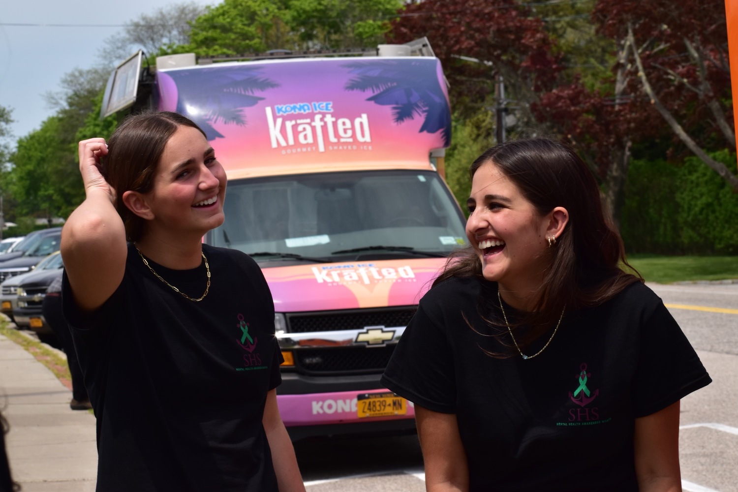 Ella Leibnitzky and Leilani Escobar share a laugh together at Saturday's cornhole tournament.  SERE MOTYKA