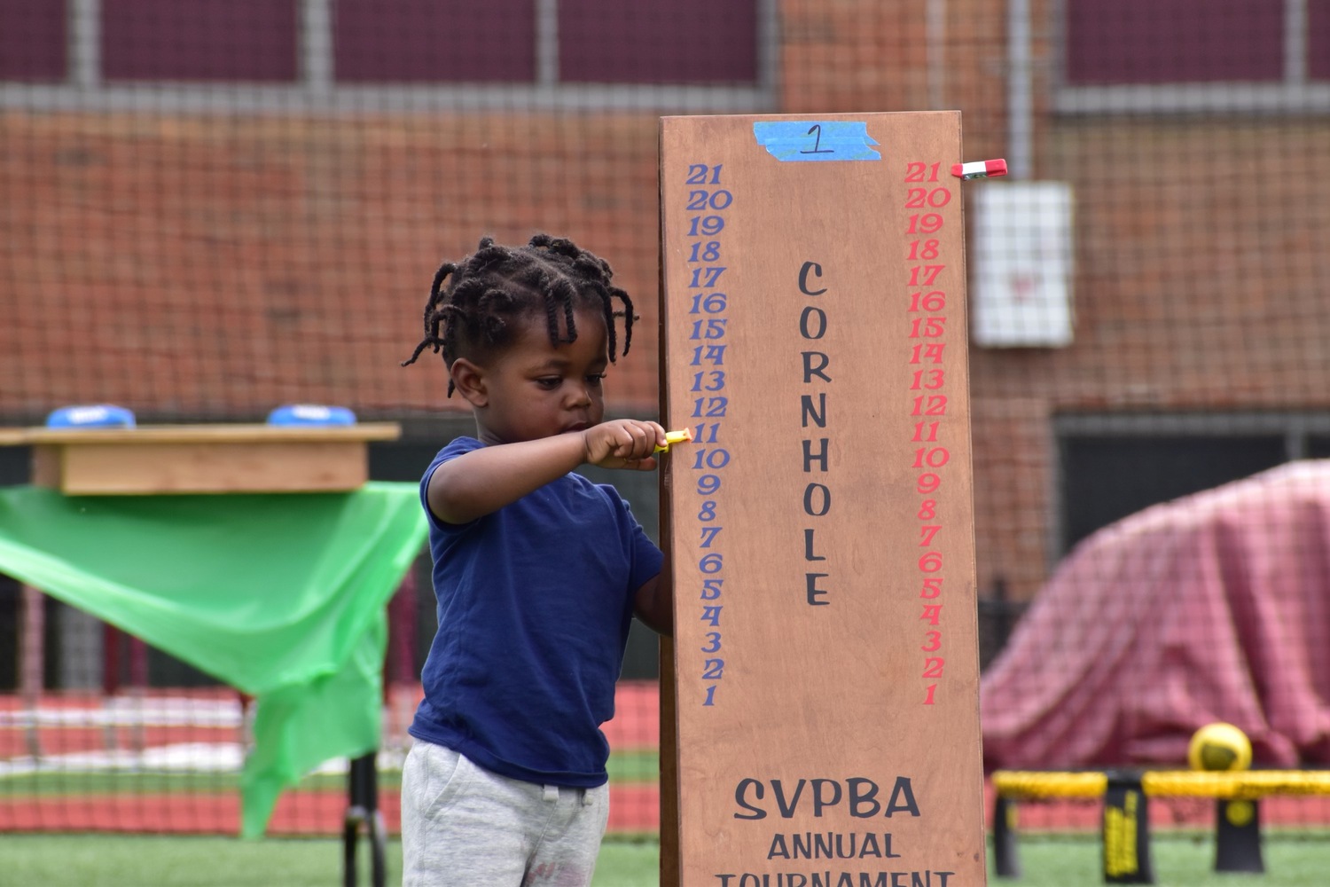 Tavian Nash having fun at the cornhole tournament.   SERE MOTYKA