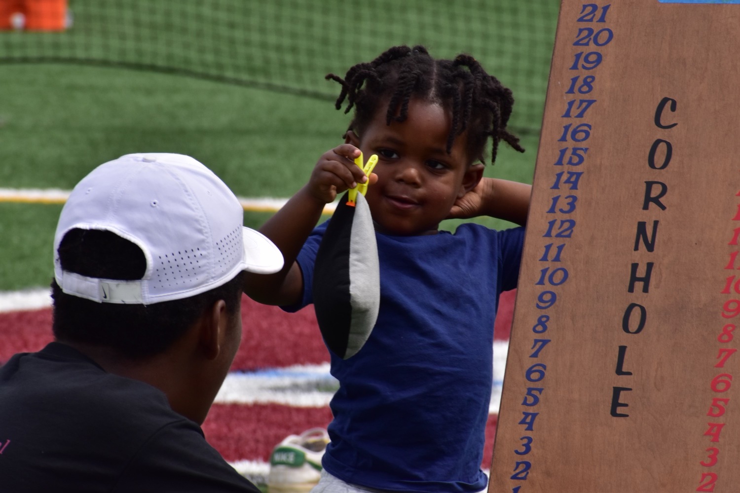 Tavian Nash having fun at the cornhole tournament.   SERE MOTYKA