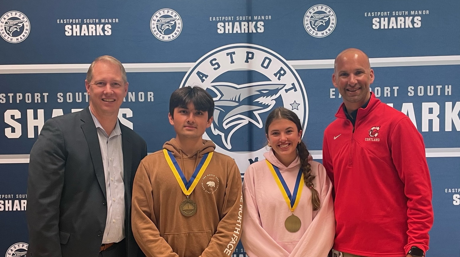 Eastport-South Manor Jr.-Sr. High School seniors Vincent Balzano and Riley Hack were recently recognized as the school's winners of the 2023 NYS AHPERD Suffolk Zone Award. Sharing their congratulations are Principal Salvatore Alaimo, left, and Director of Health, Physical Education and Athletics Kevin Trentowski, right. COURTESY EASTPORT-SOUTH MANOR SCHOOL DISTRICT