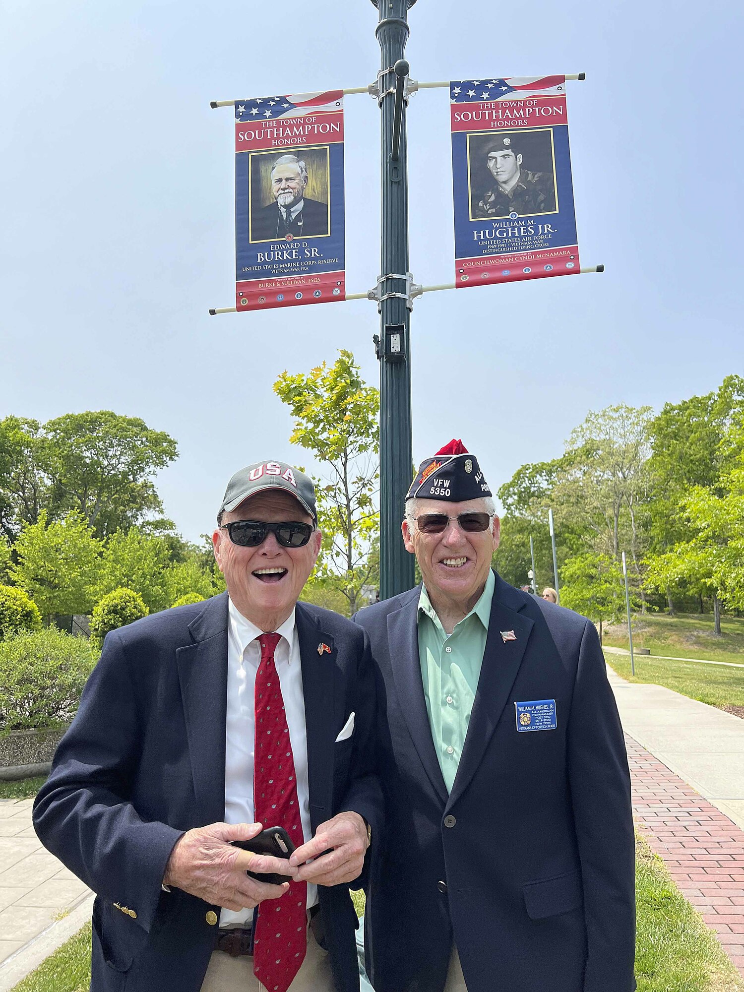 Judge Edward D. Burke Sr. and William M. Hughes Jr. with their banners in Good Ground Park.  DANA SHAW
