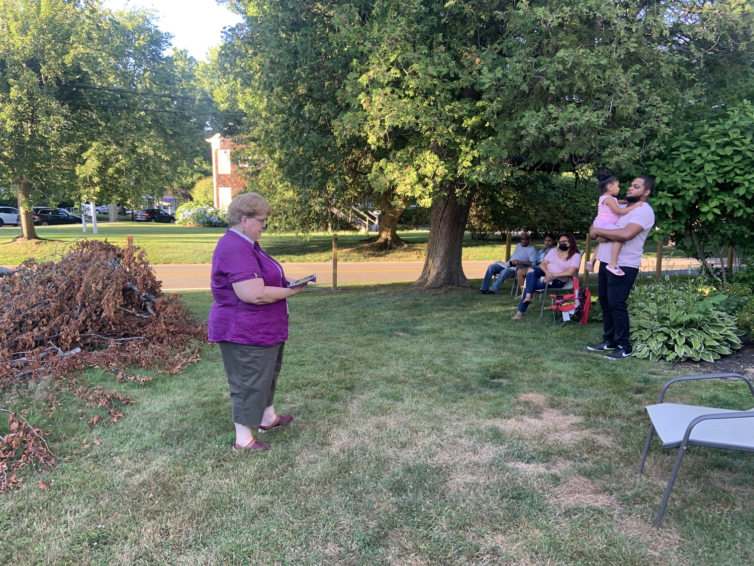 The Reverend Joanne Utley leads a prayer service at the foot of  the damaged and diseased 150-year-old European weeping beech next to the former Bridgehampton United Methodist Church Prior to its removal in July 2022.  STEPHEN J. KOTZ