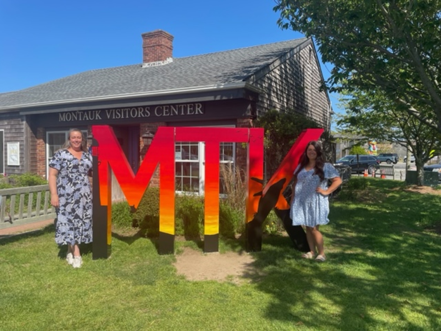 Artist Angela Filangeri, right, and Montauk Chamber of Commerce Executive Director Jennifer Fowkes in front of the new MTK sign. COURTEST MONTAUK CHAMBER OF COMMERCE