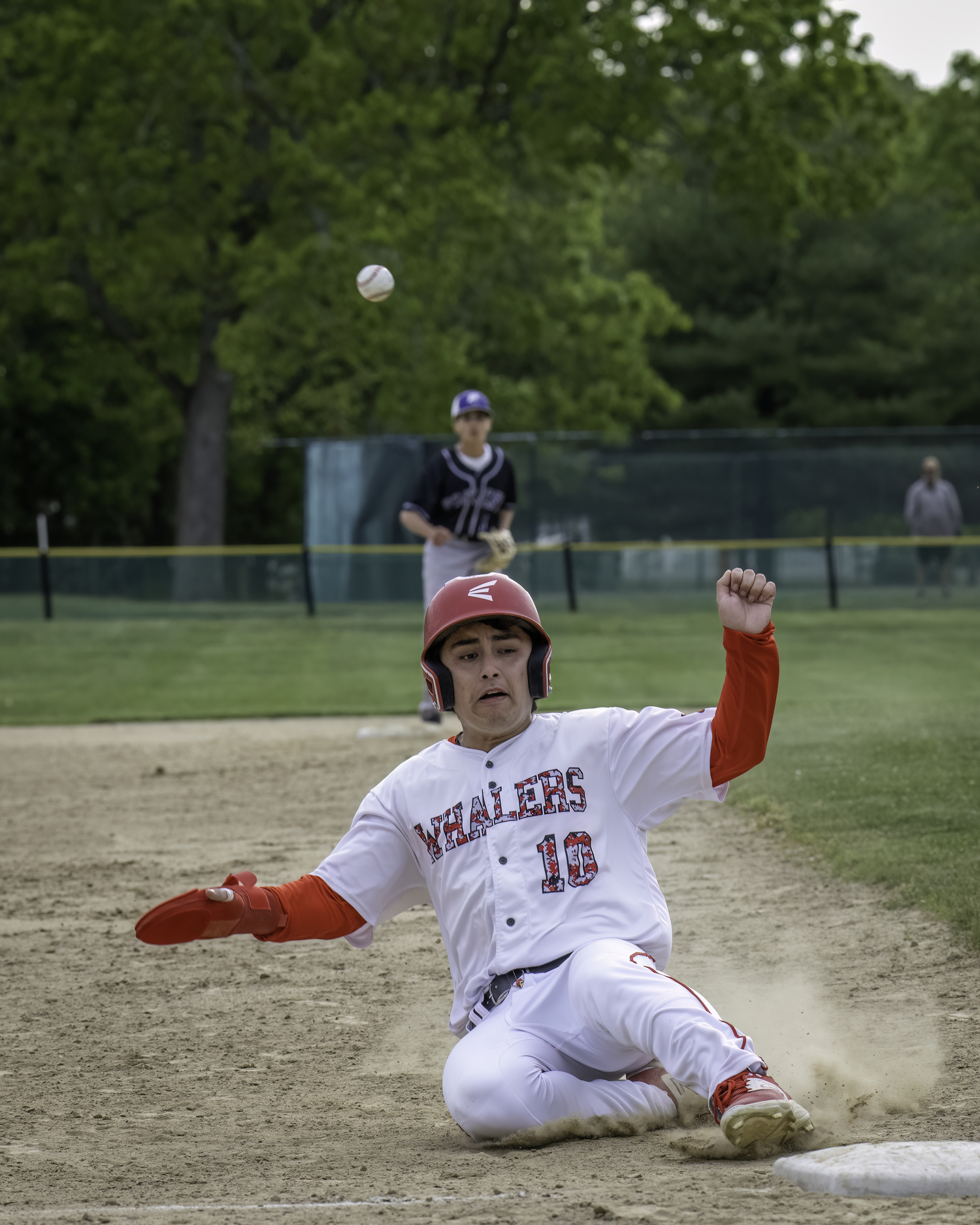 Max Krotman slides in safely to third base well ahead of the incoming throw.   MARIANNE BARNETT