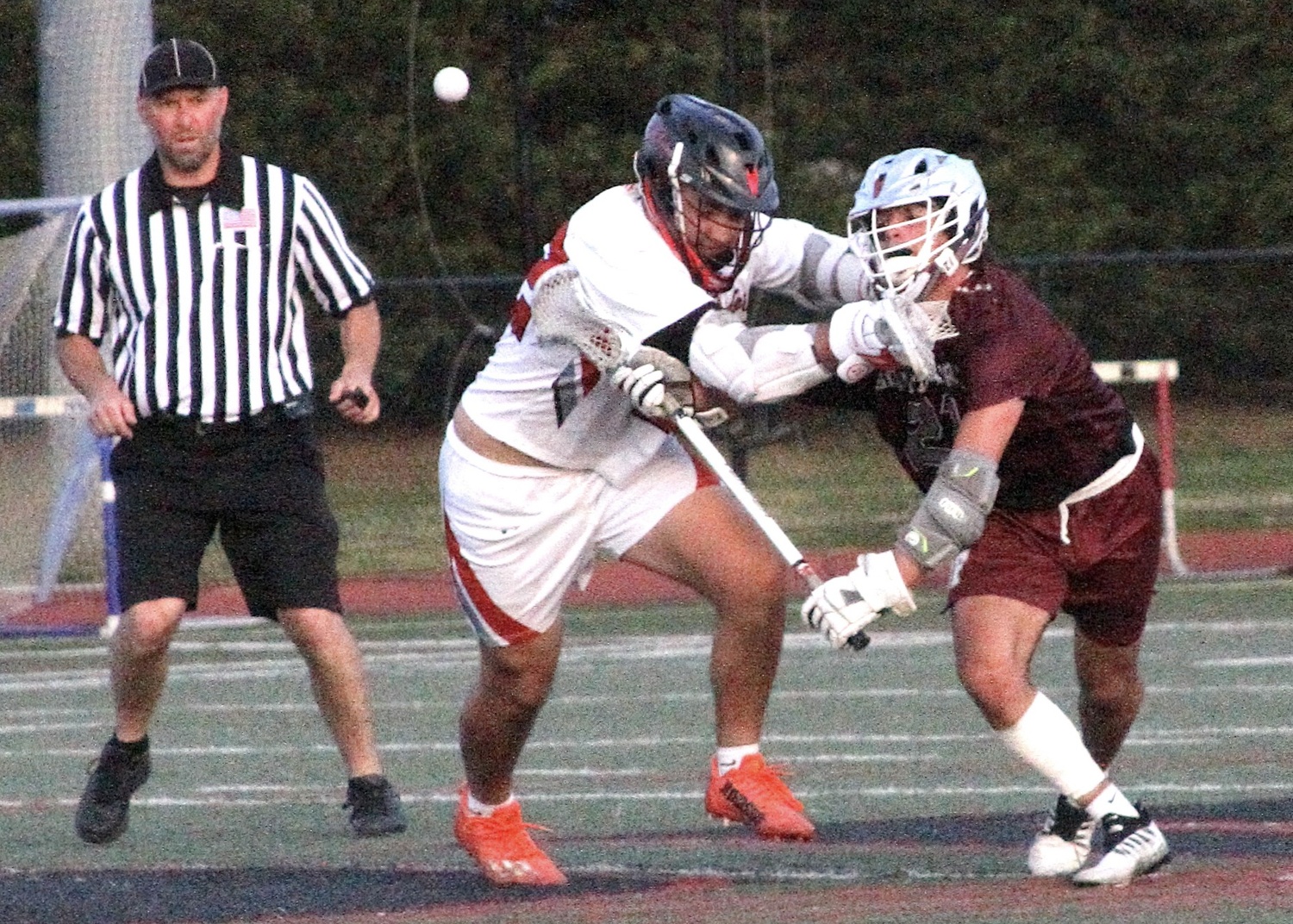 Junior midfielder Jack Cooper keeps his eyes on the ball while being checked off the faceoff. DESIRÉE KEEGAN