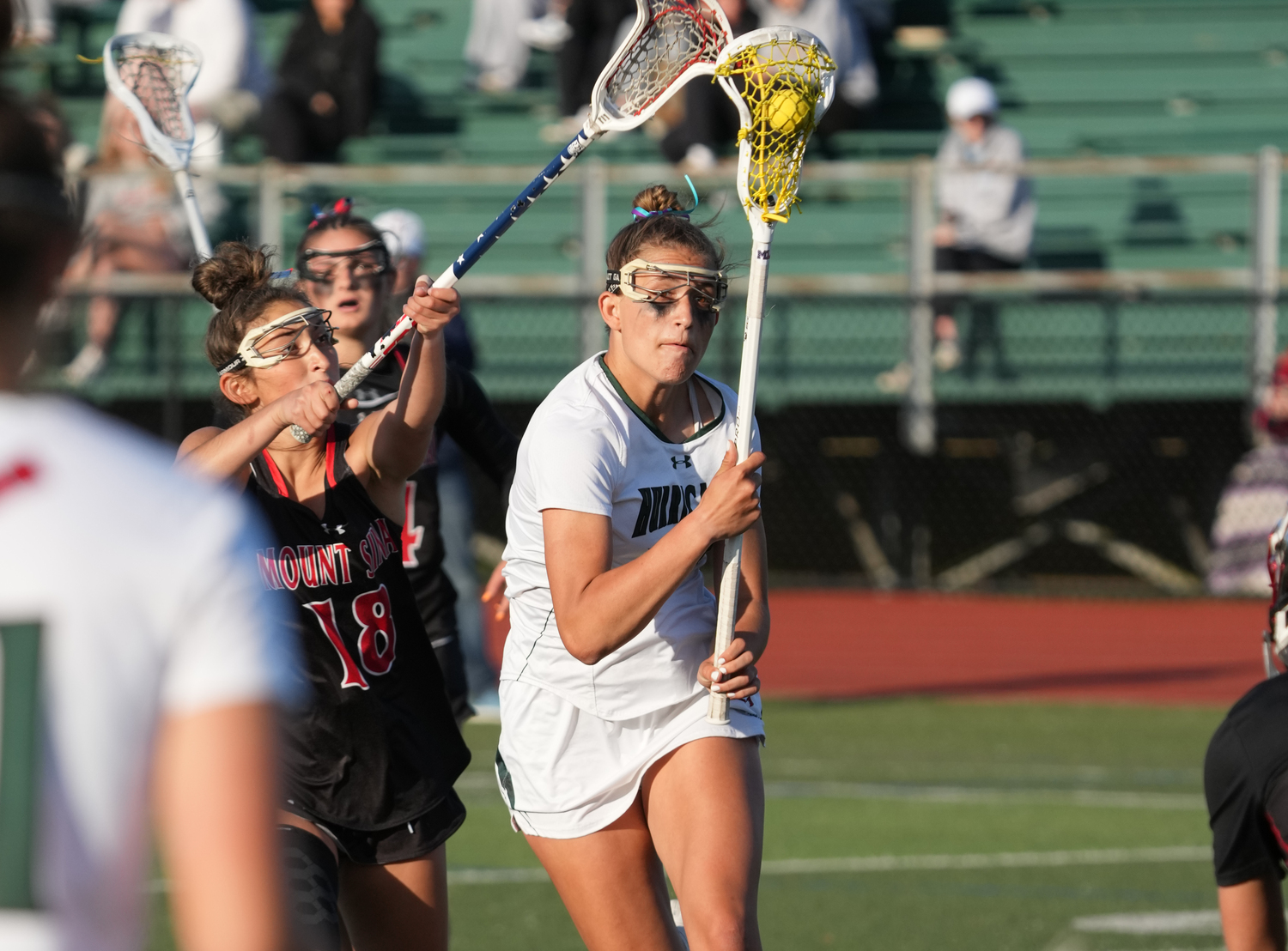 Sophomore midfielder Reese King protects as she moves the ball toward the cage off a free position. RON ESPOSITO