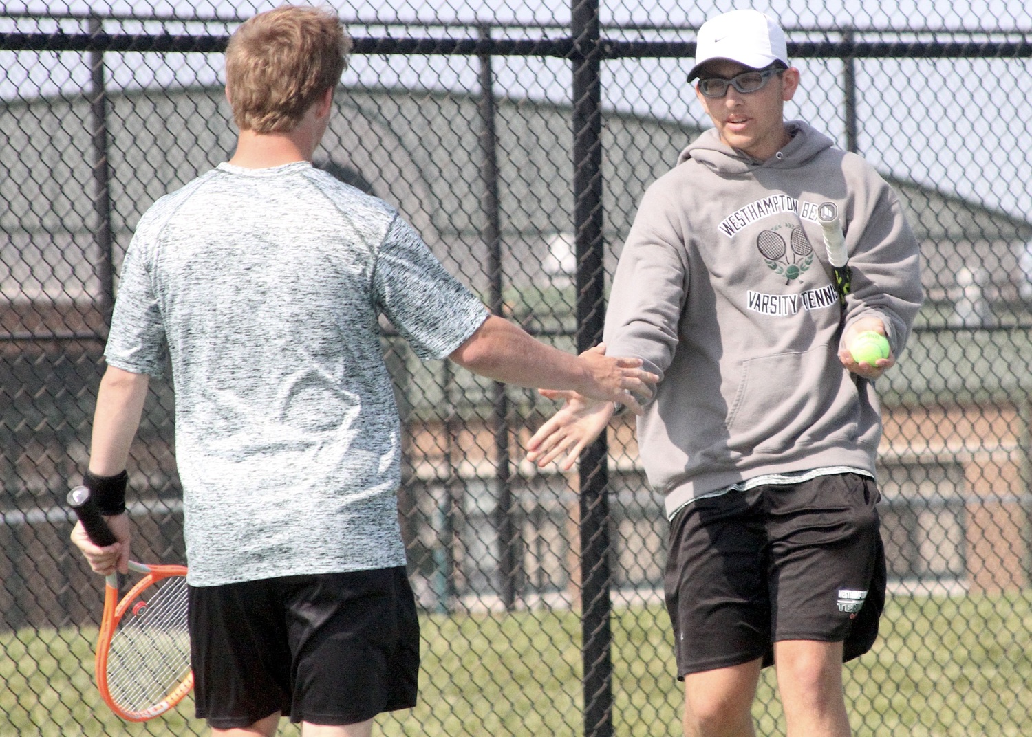 Sophomore Giancarlo Volpe celebrates a point with doubles teammate Bobby Stabile. DESIRÉE KEEGAN