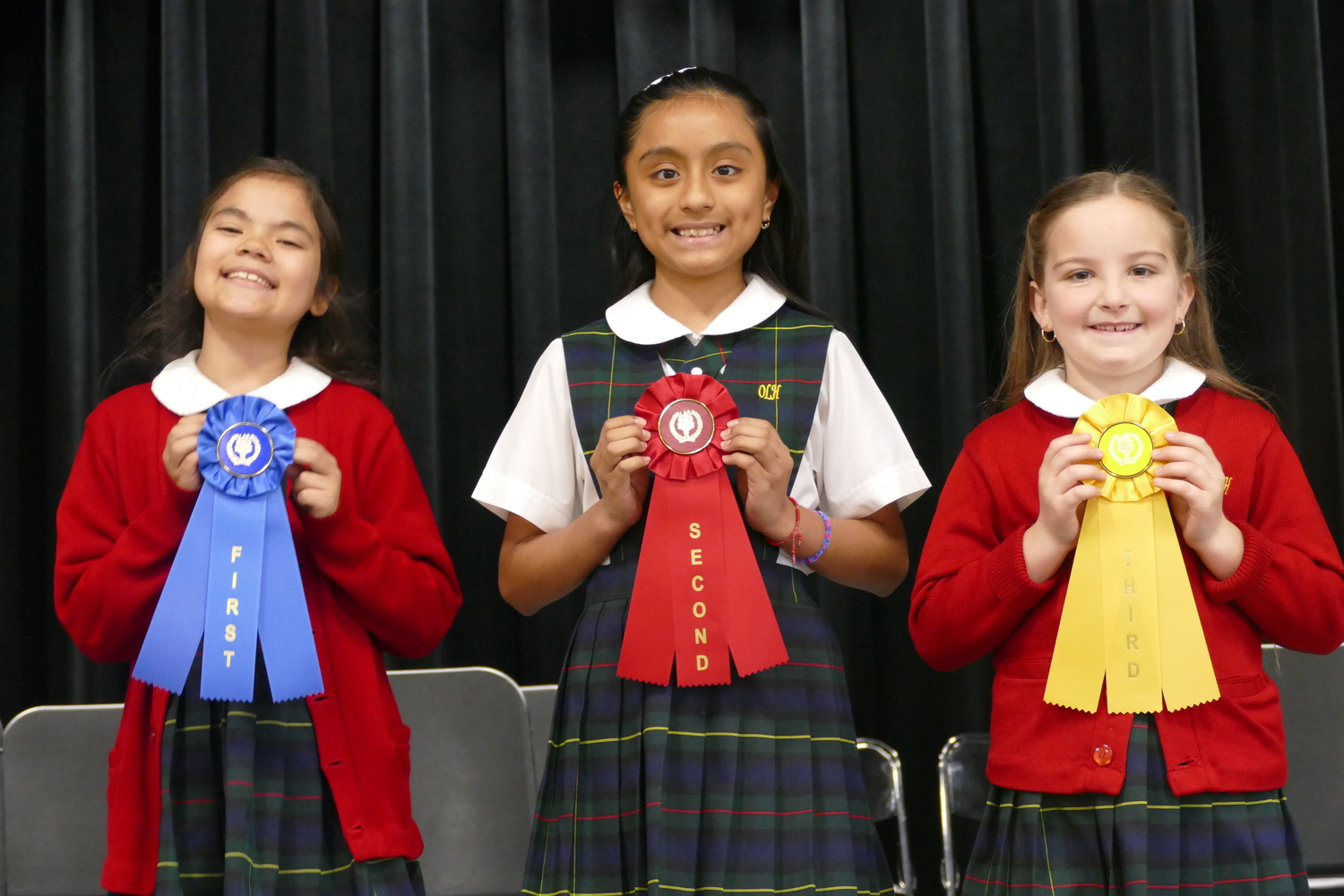 Our Lady of the Hamptons School students, from left, Michelle Rojas, Ahani Velecela and Kennedy McGhee with their spelling awards. COURTESY OUR LADY OF THE HAMPTONS SCHOOL