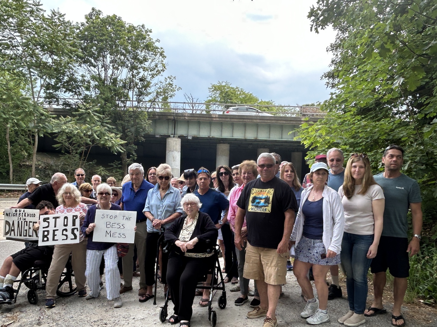 Dozens of community members gathered in opposition to a Battery Energy Storage System planned just beyond the Sunrise overpass in their Hampton Bays neighborhood.   KITTY MERRILL
