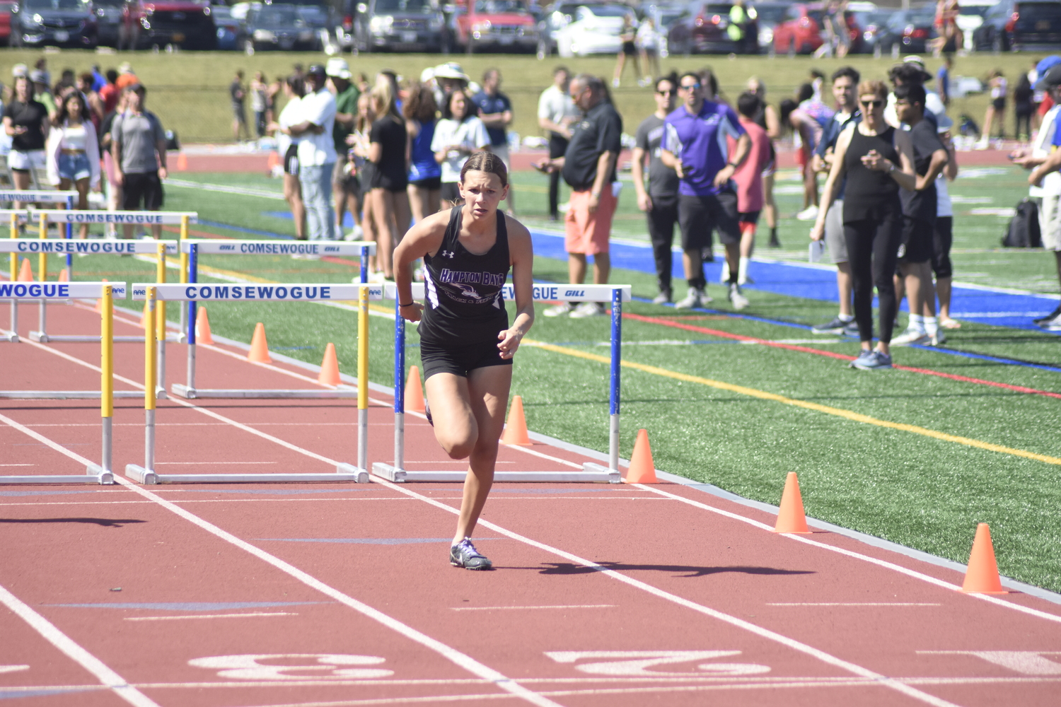 Hampton Bays junior Allie O'Brien finishes the 100-meter hurdles of the pentathlon.   DREW BUDD