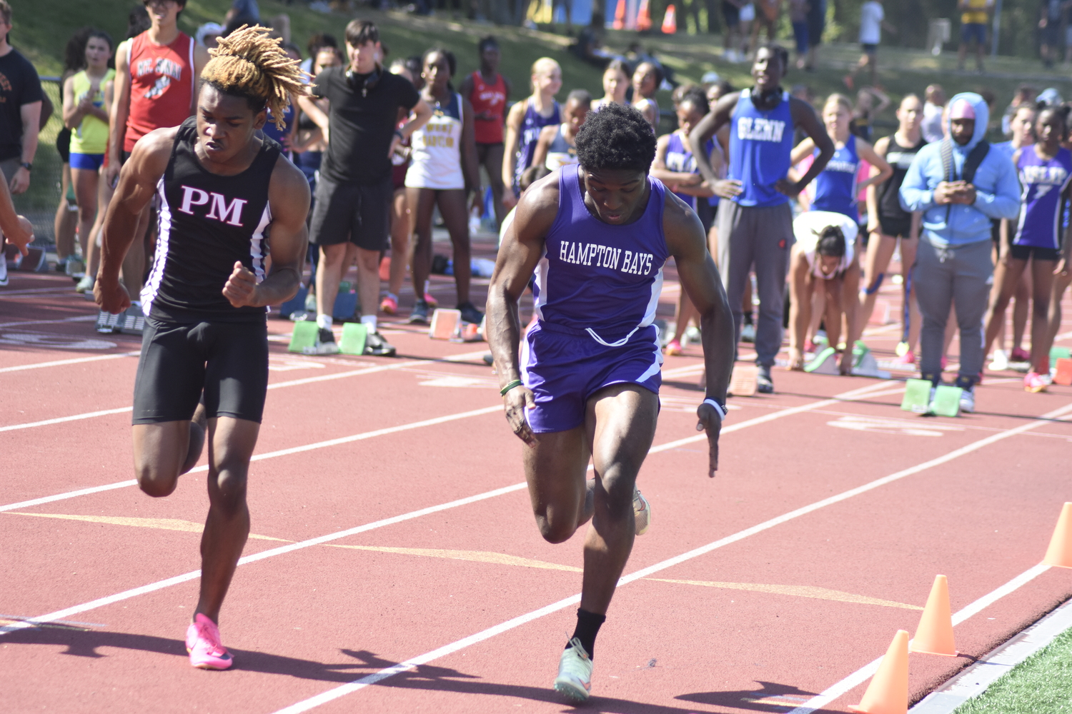 Hampton Bays senior Eli Amos at the start of the 100-meter dash.   DREW BUDD