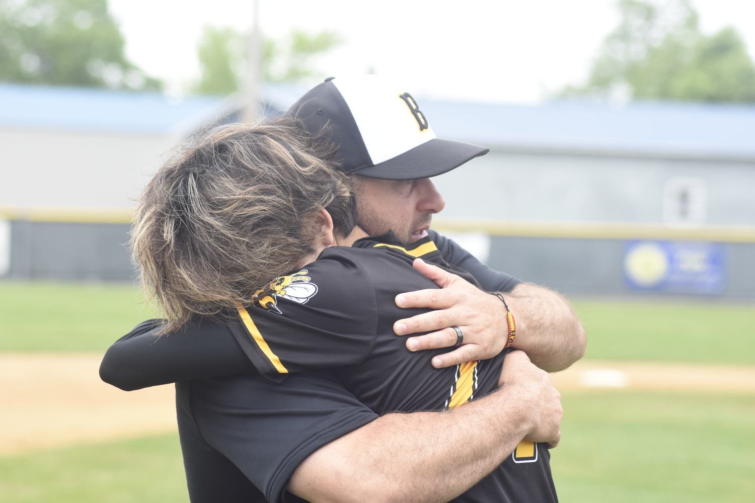 Bridgehampton Athletic Director and assistant coach Mike DeRosa consoles Ross senior Yudai Morikawa after the team's loss in the regional final on Saturday.   DREW BUDD