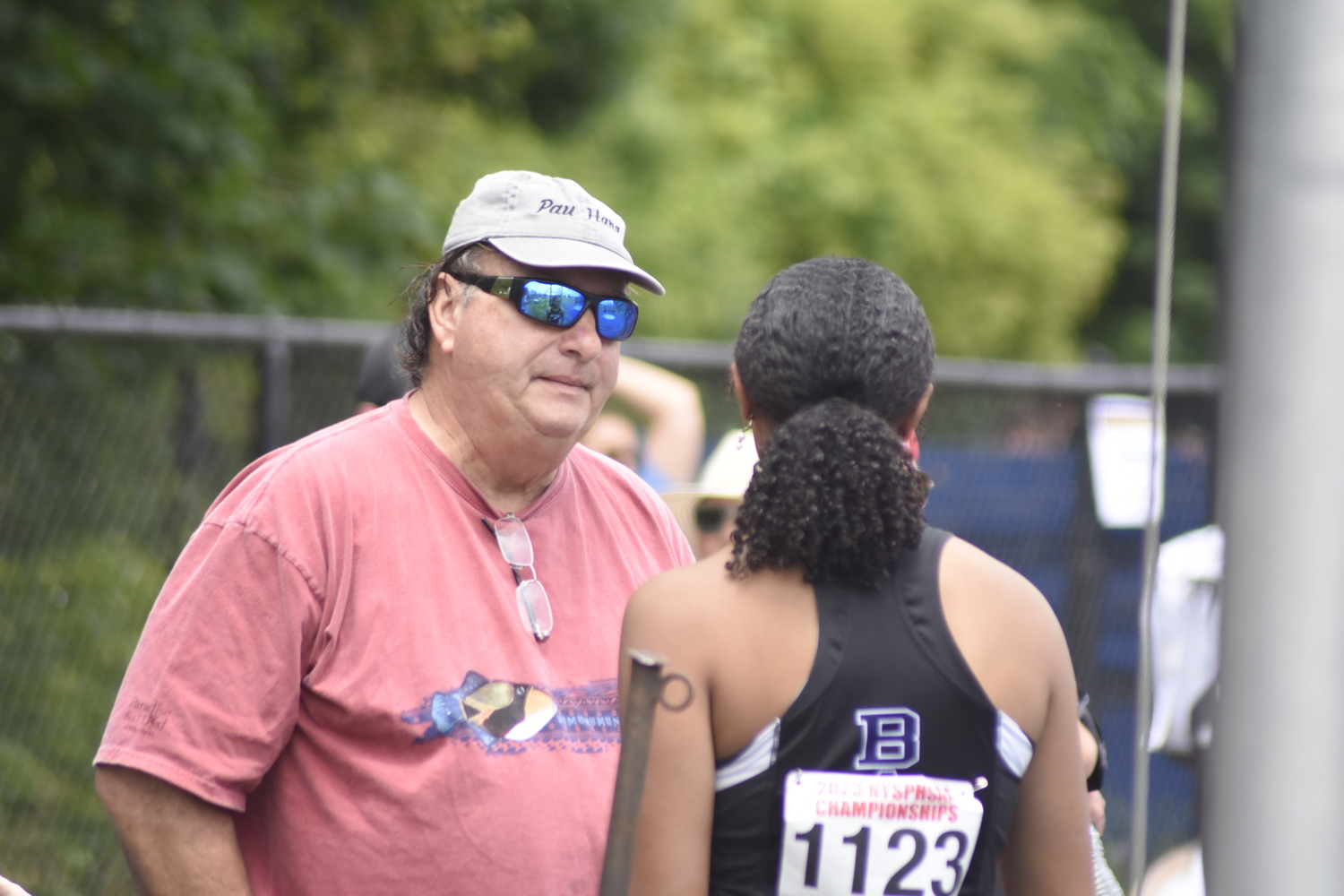 Asha Pensa-Johnson gets some tips from her grandfather Charlie Pensa just before the start of the discus at the New York State Track and Field Championships in Middletown this past weekend.   DREW BUDD