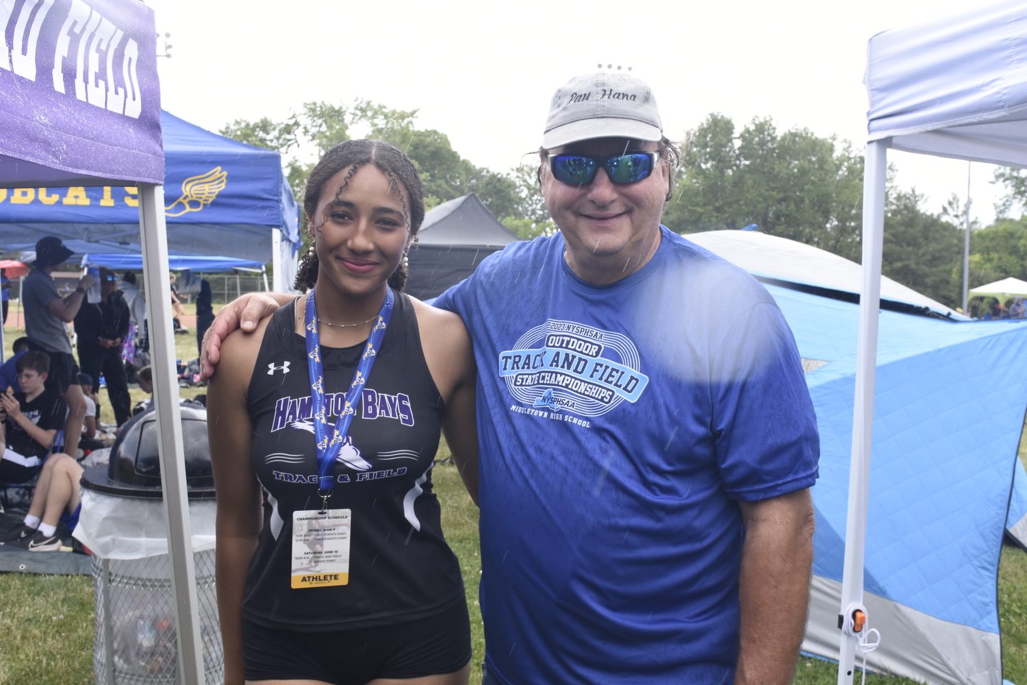 Hampton Bays sophomore Asha Pensa-Johnson with her grandfather Charlie Pensa in tent city at the New York State Track and Field Championships on Friday.   DREW BUDD
