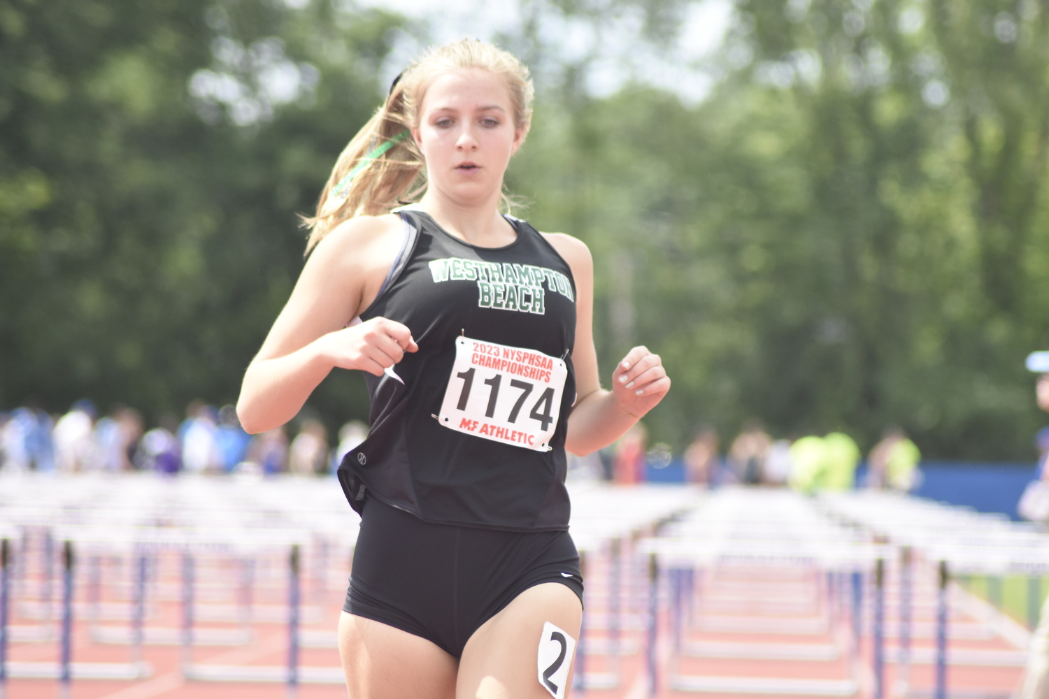 Westhampton Beach junior Madison Phillips finishes  the 100-meter hurdles of the pentathlon.   DREW BUDD