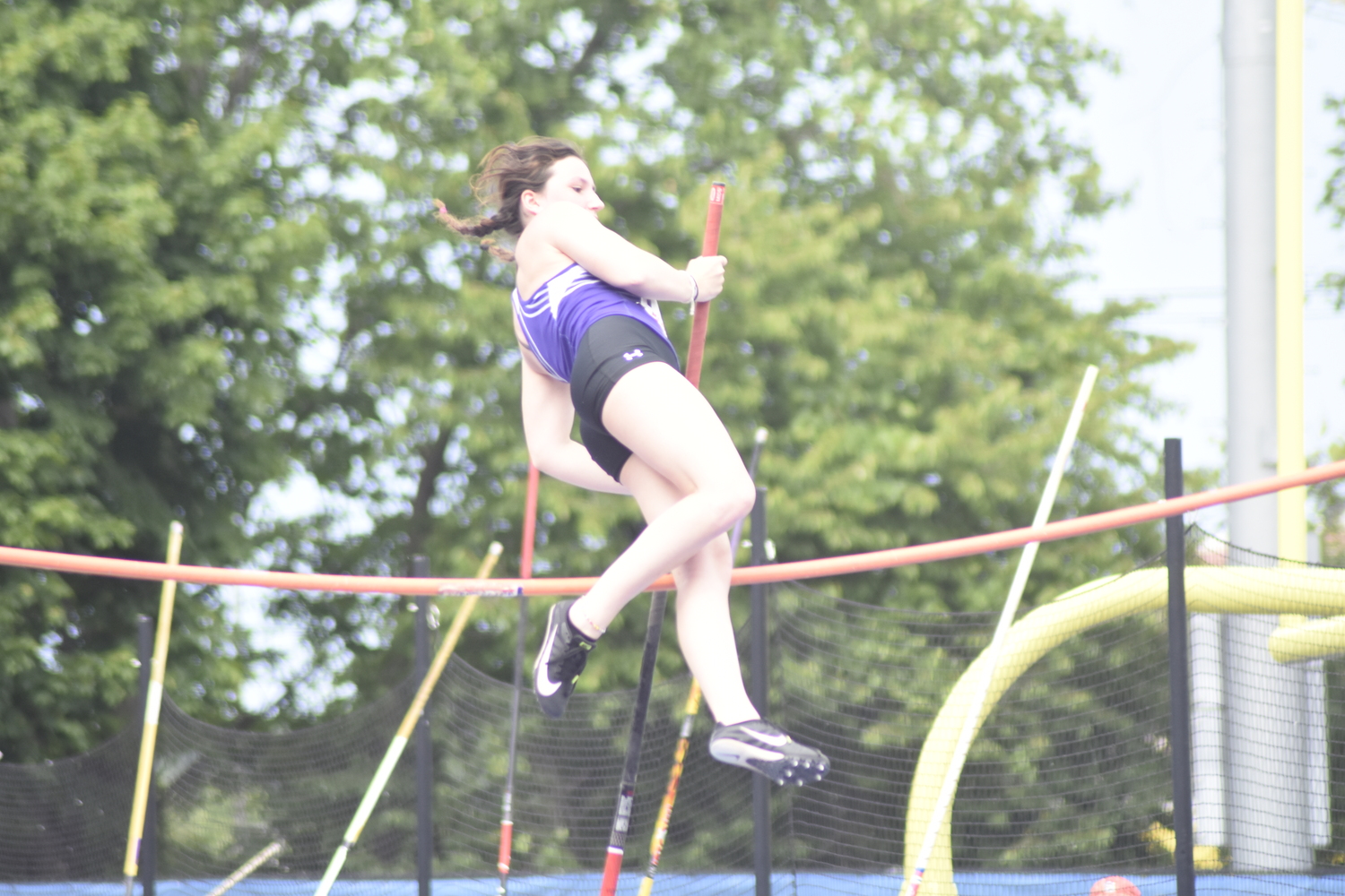 Hampton Bays senior Maizie Poulakis tries to clear the opening height of 9 feet in the pole vault.   DREW BUDD