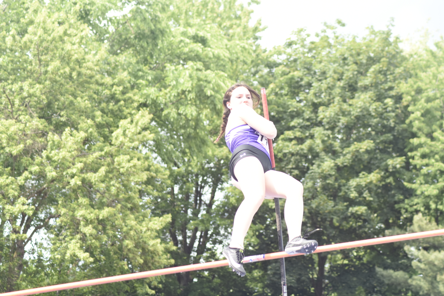 Hampton Bays senior Maizie Poulakis tries to clear the opening height of 9 feet in the pole vault.   DREW BUDD