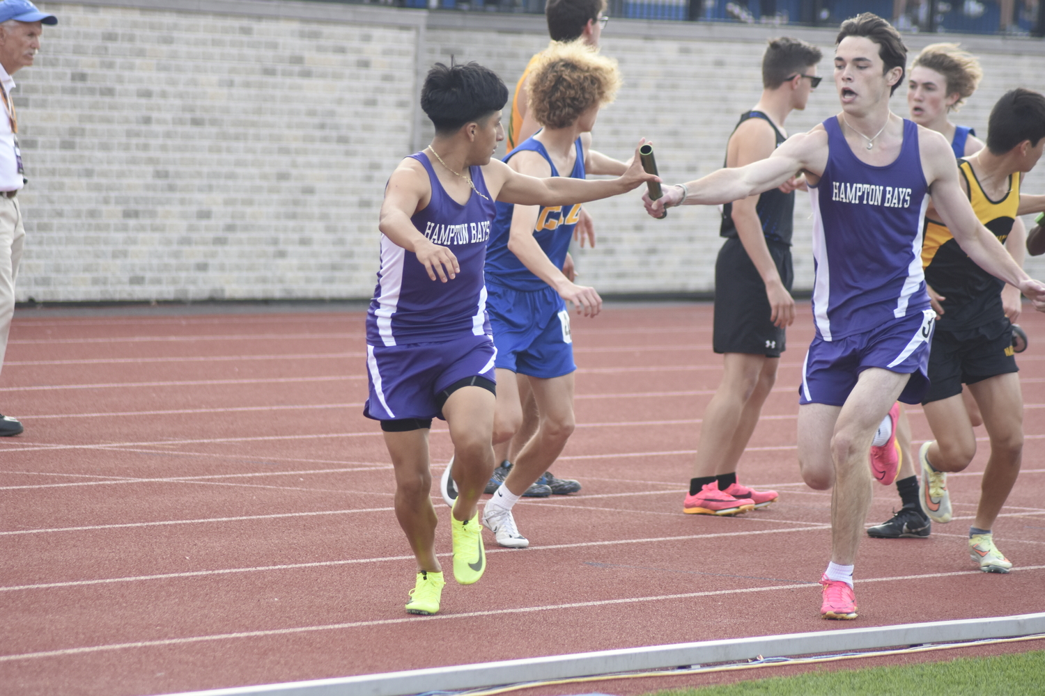 Eddy Benenaula takes the baton from Liam Sutton.  DREW BUDD