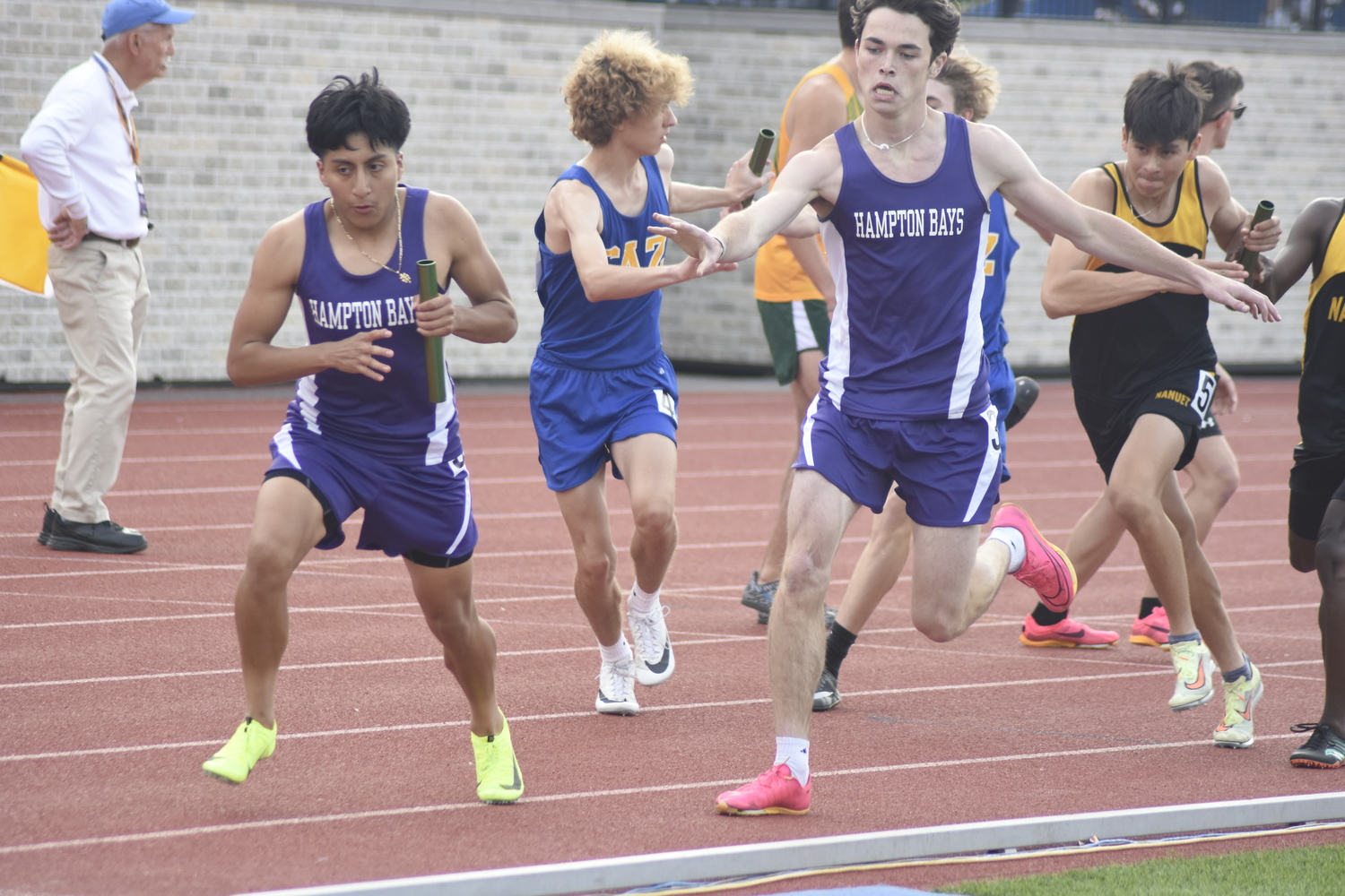 Eddy Benenaula takes the baton from Liam Sutton.  DREW BUDD