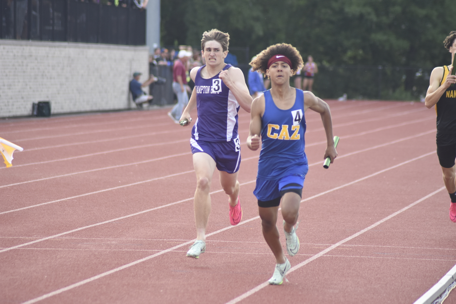 Matthew Papajohn races a Cazenovia runner to the finish line. The Baymen finished second in their heat, 11th overall in the 4x400-meter relay.   DREW BUDD