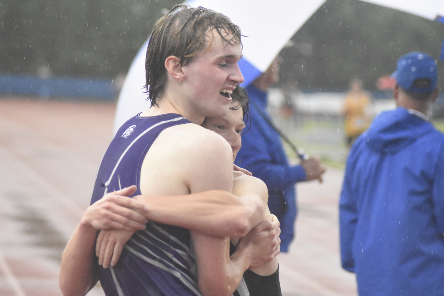 Max Haynia and Monroe-Woodbury senior Collin Gilstrap hug after Gilstrap won the 3,200-meter race on Friday. Gilstrap and Haynia have battled it out in both cross country and track over the years and both are seniors.   DREW BUDD