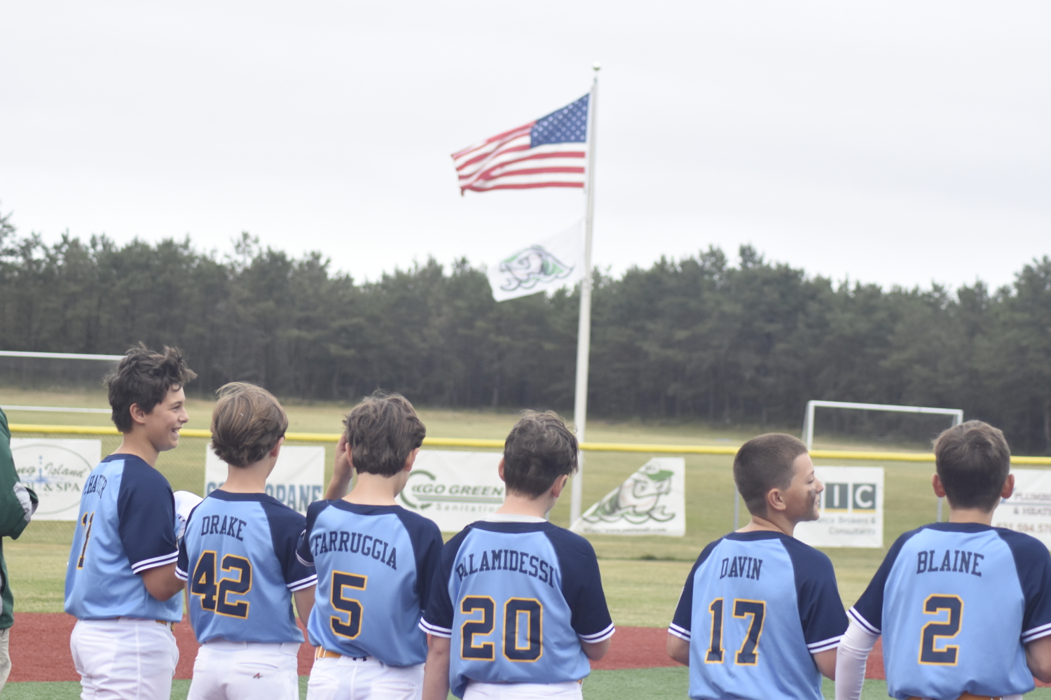 The East End 12U baseball All-Stars line up for the national anthem just prior to their opening game of the District 36 Tournament at Hampton West Park in Westhampton on Thursday, June 22.   DREW BUDD