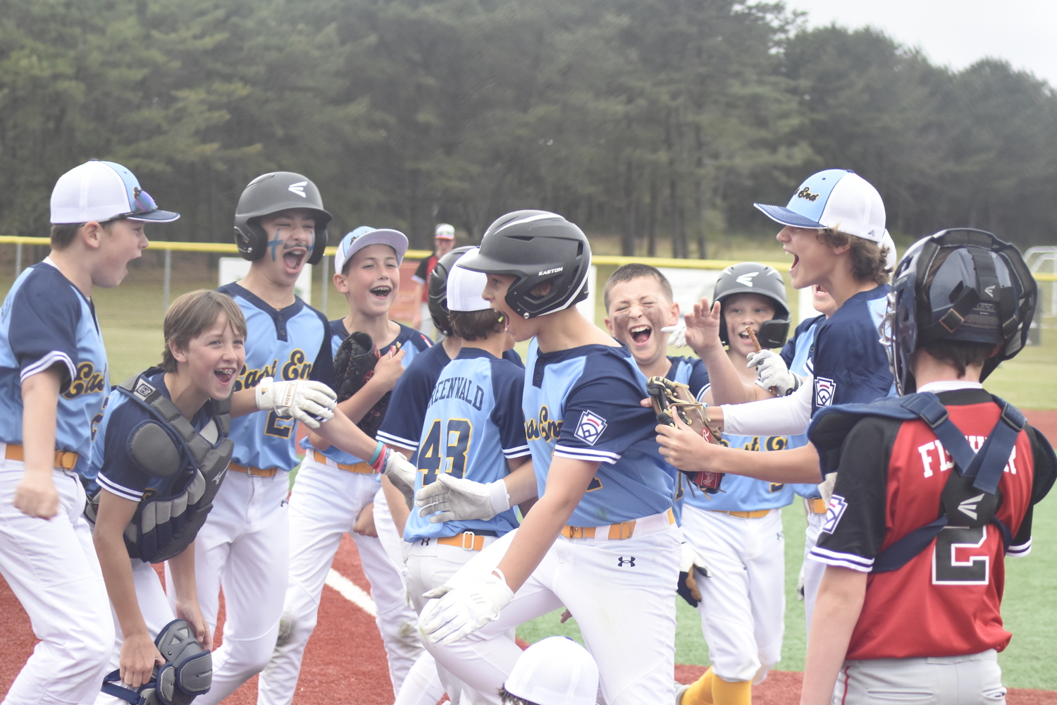 Blake Schaffer is mobbed at home plate by his teammates after his game-tying home run against Sag Harbor last week.   DREW BUDD