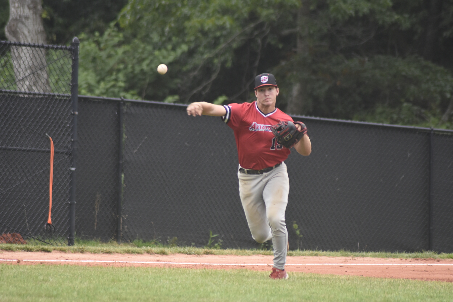 Westhampton third baseman Greg Marmo (Gonzaga) throws to first base for an out after fielding a ground ball.   DREW BUDD