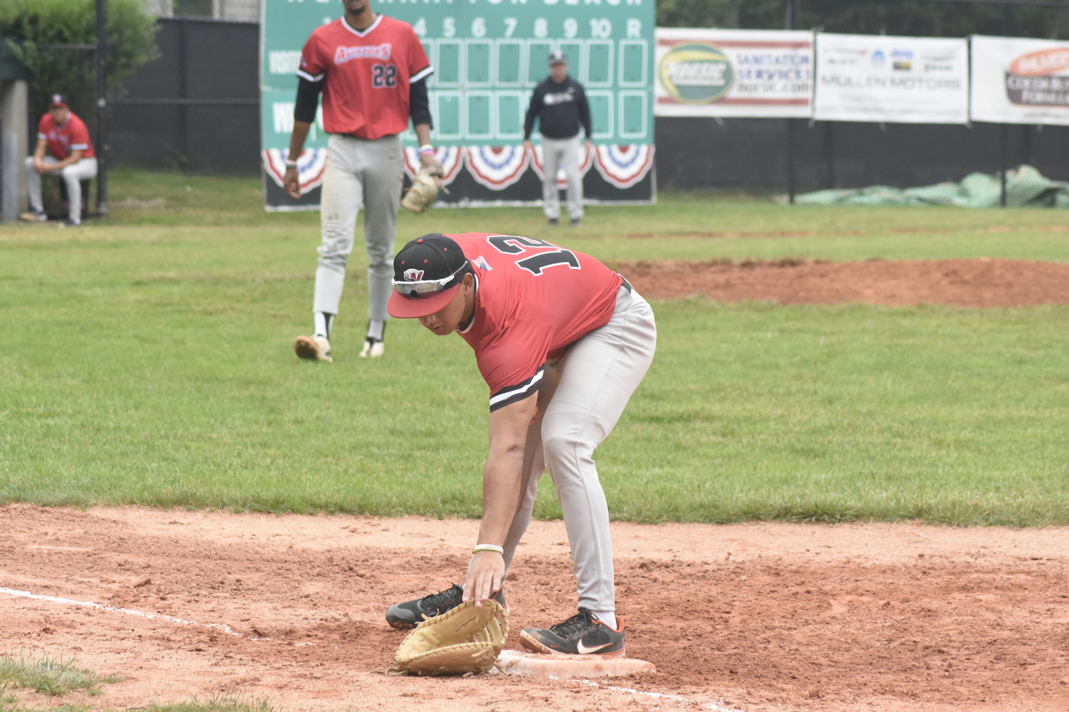 Westhampton first baseman Luke Mistone (Cal State Fullerton) loses his glove after fielding a ground ball close to the foul line, but he grabs the ball and steps on first base for the out.   DREW BUDD