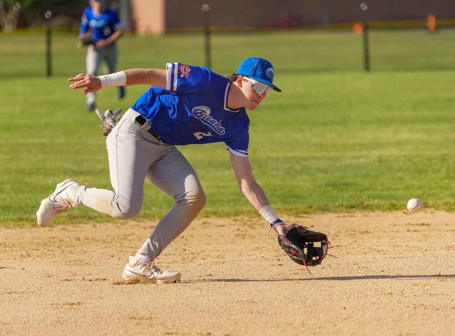 Breakers shortstop Michael Coyne (Georgetown) charges a ground ball.   RON ESPOSITO