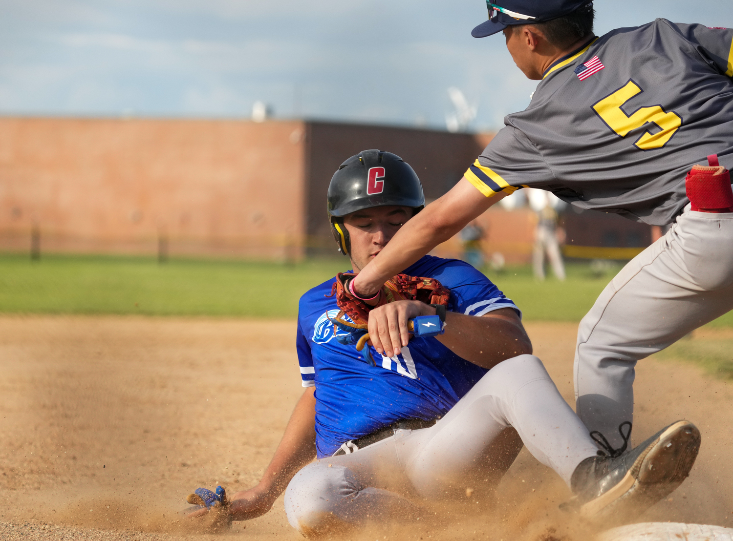 Mitchel Johnson (Catholic) slides into third base.   RON ESPOSITO