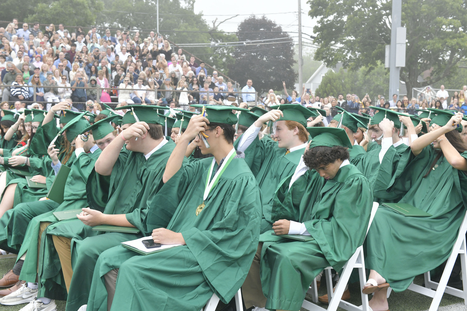 Graduates move their tassels at Westhampton Beach Graduation on Friday evening.  DANA SHAW