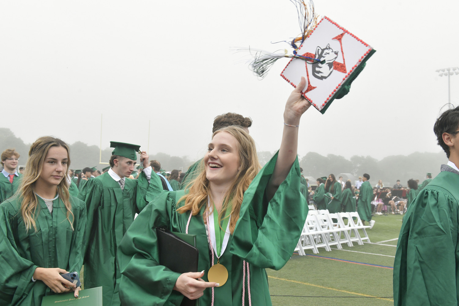 Westhampton Beach Valedictorian Megan Sitzmann waves to the crowd at graduation on Friday evening.  DANA SHAW