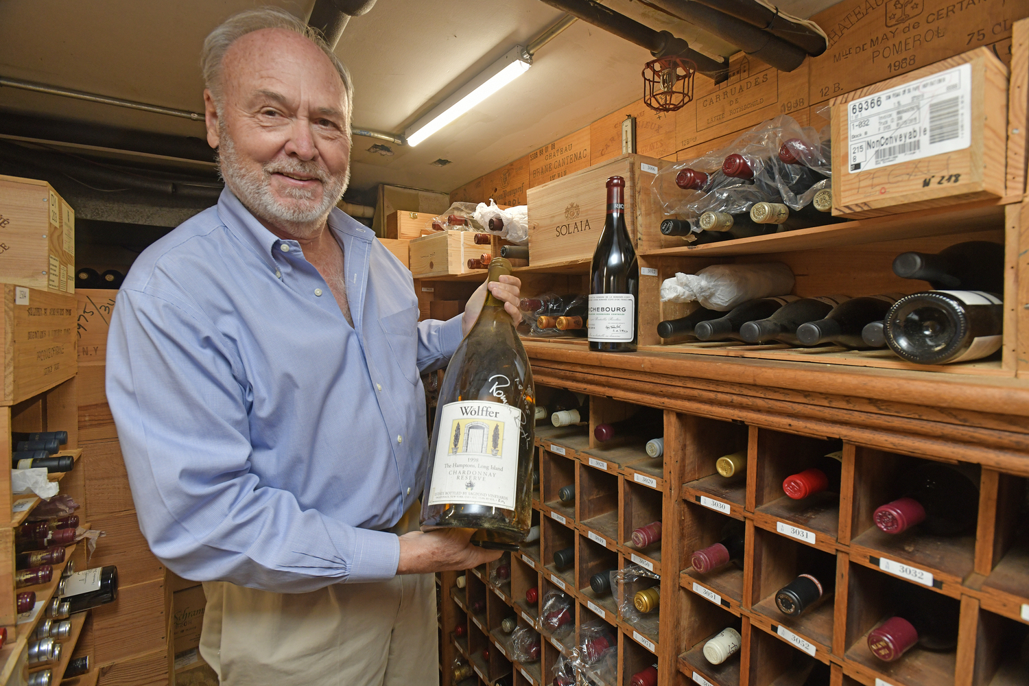 Ted Conklin in the wine cellar at the American Hotel in Sag Harbor with a 1998 Wolffer Chardonnay Reserve in a Jeroboam.  DANA SHAW