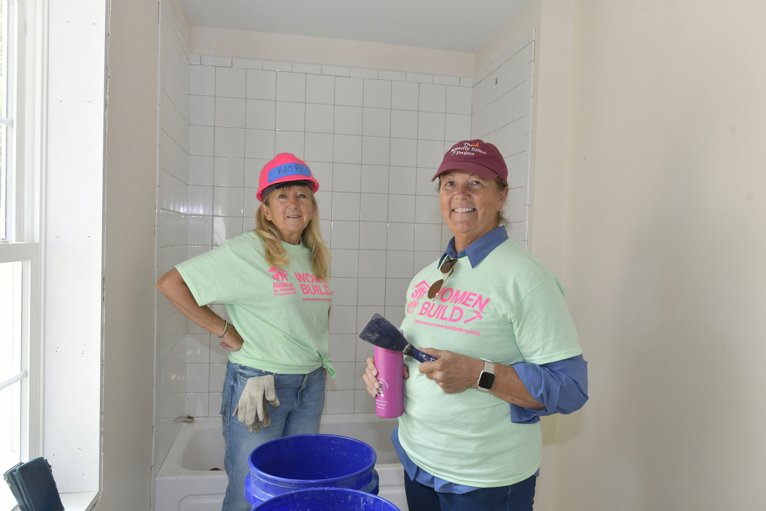 Kathy Daly and Linda Borenstein get ready to grout one of the bathrooms.  DANA SHAW