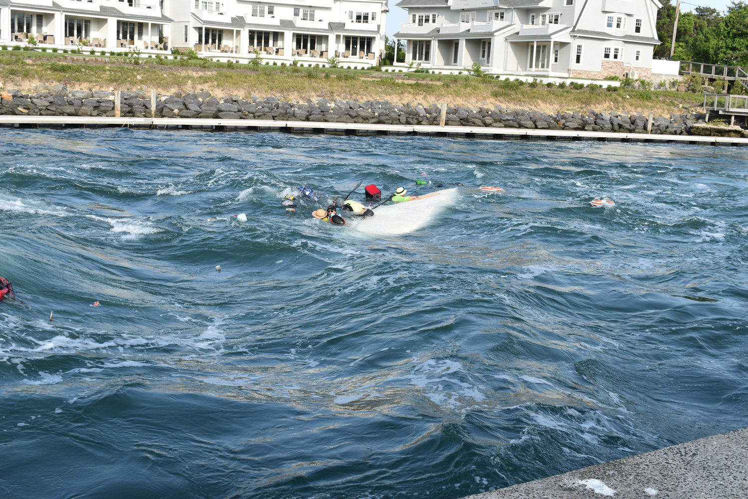 Six people  on a multiday canoe journey from Boston to New York City were passing through the Shinnecock Canal on Friday when a motorboat going the opposite direction began zig-zagging, creating a wake that swamped the canoe.    STEPHEN J. KOTZ